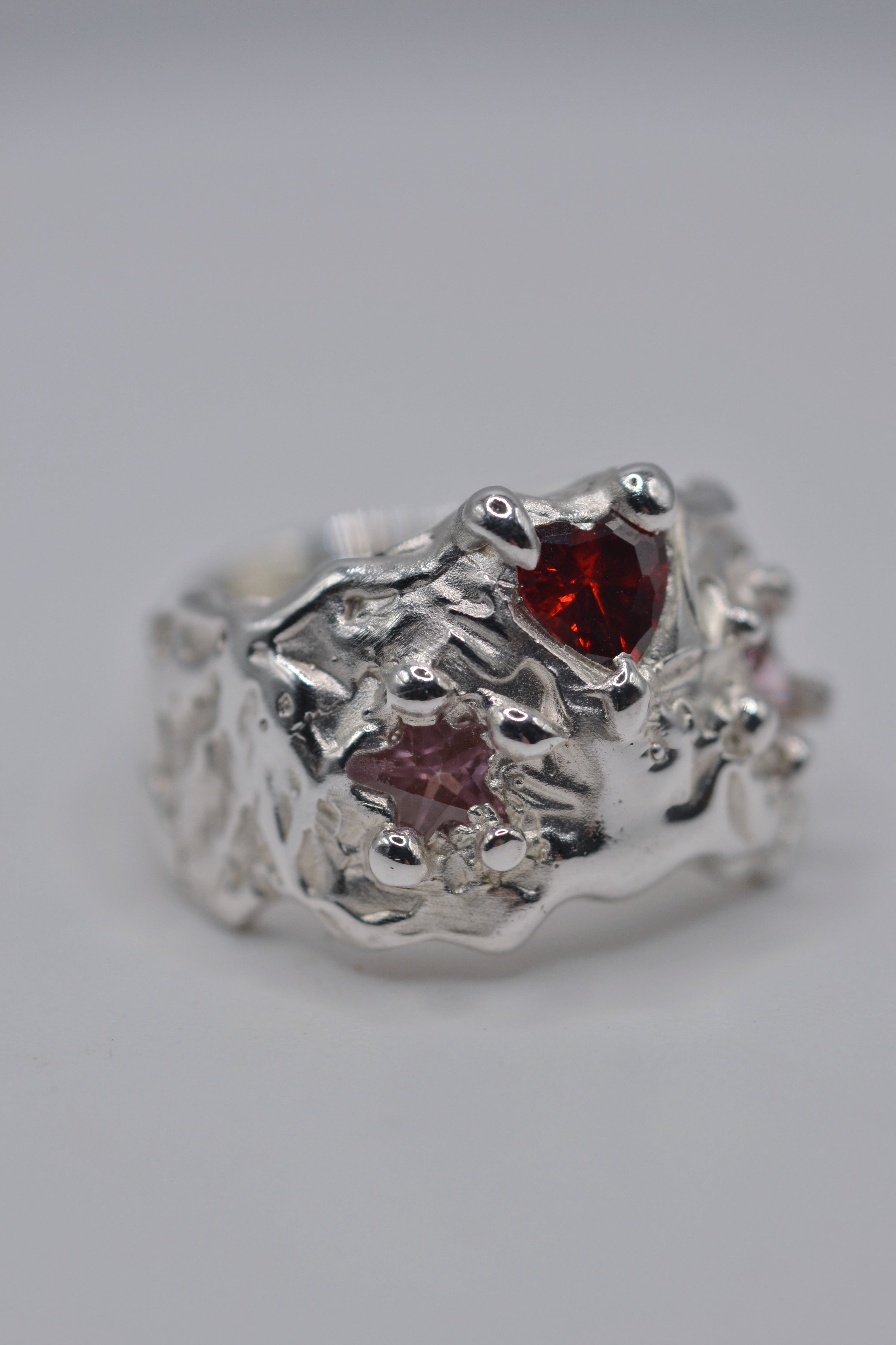 Alternative engagement ring in sterling silver. Handmade lost wax ring with red stone, cosmic cowgirl style. Metal Bones Jewellery.