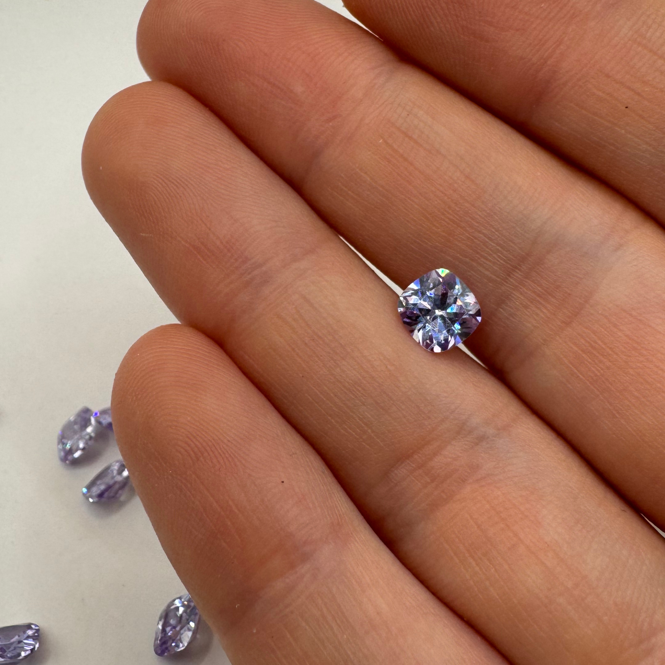 Handpicked 6x6mm square cushion amethyst crystal, showcasing an ethereal quality for unique jewellery designs.