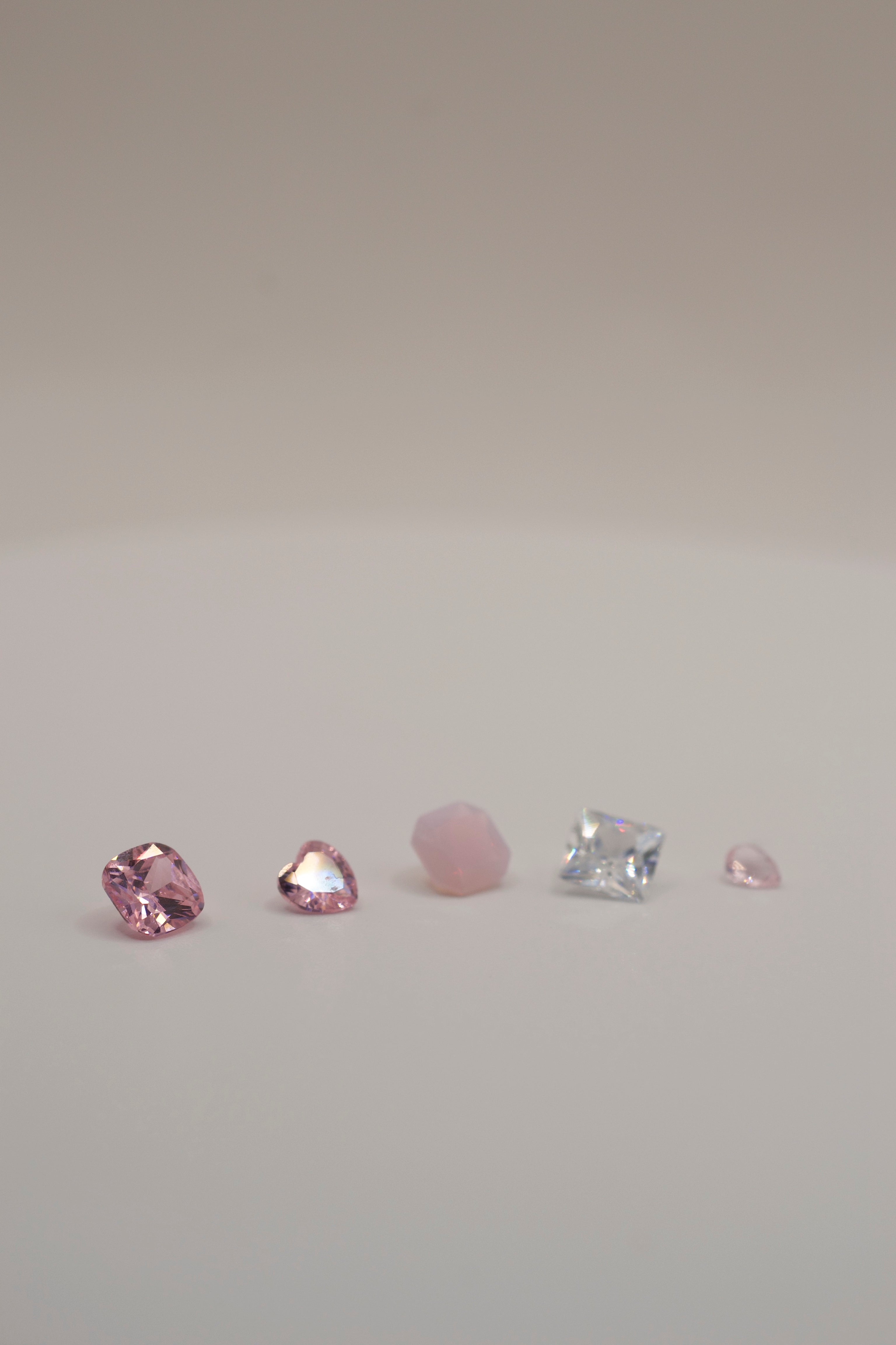 Selection of pink and clear faceted gemstones, designed for cast in place wax carving jewelry making in silver and gold.