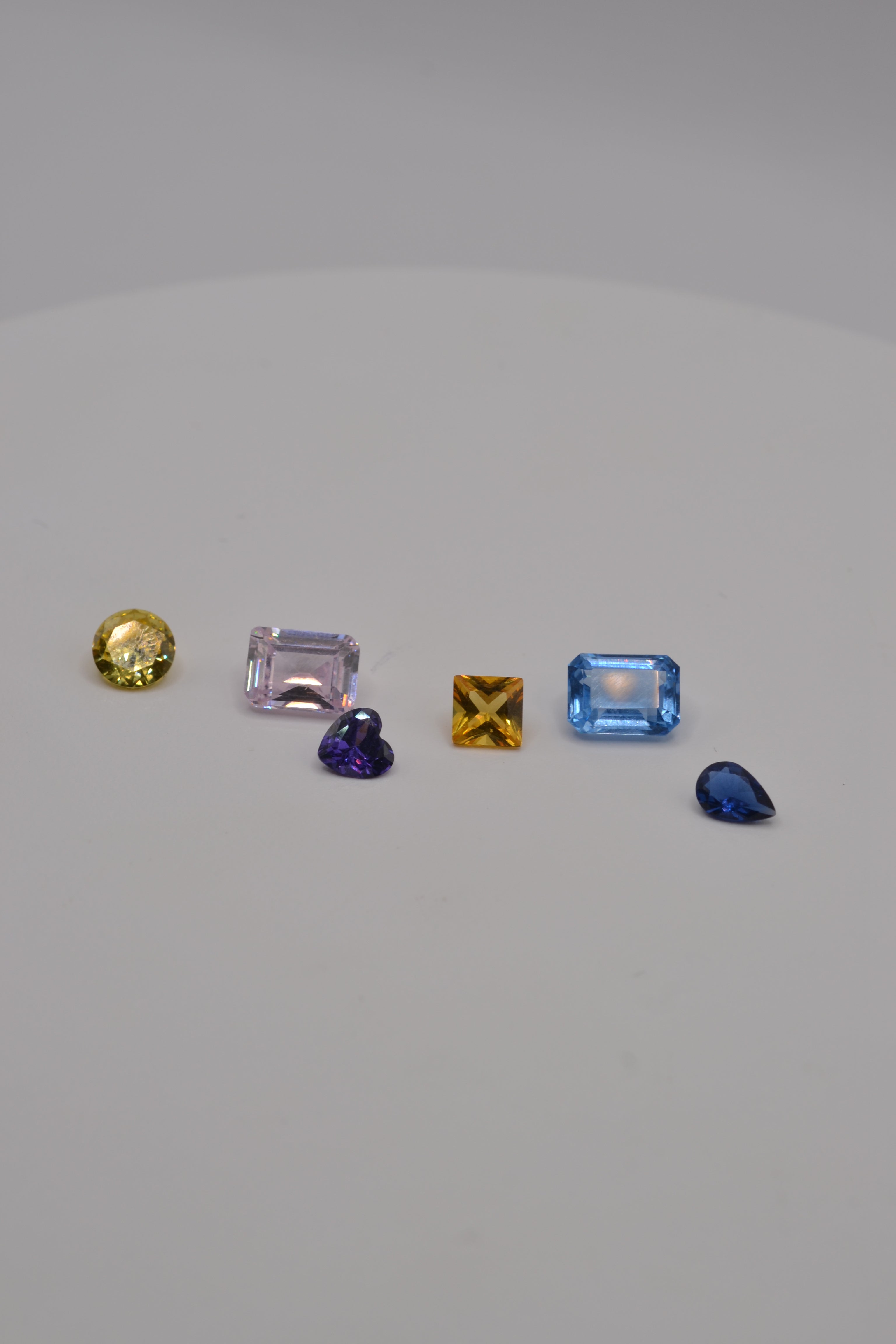 Multi coloured fancy cut gemstones for cast in place designs using the lost wax method front view