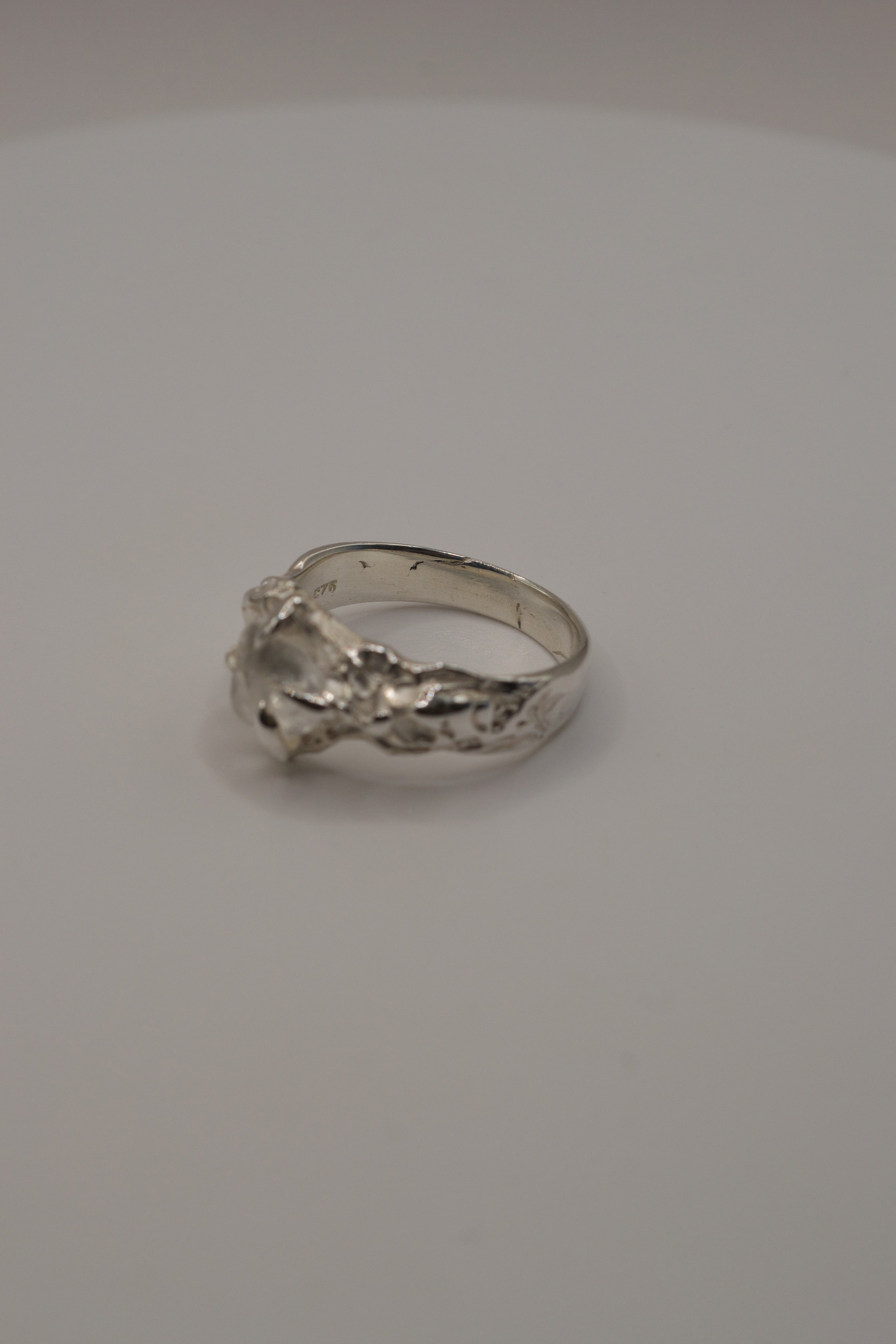 Handmade lost wax sterling silver ring, molten organic design with raw irregular clear quartz, alternate side view.