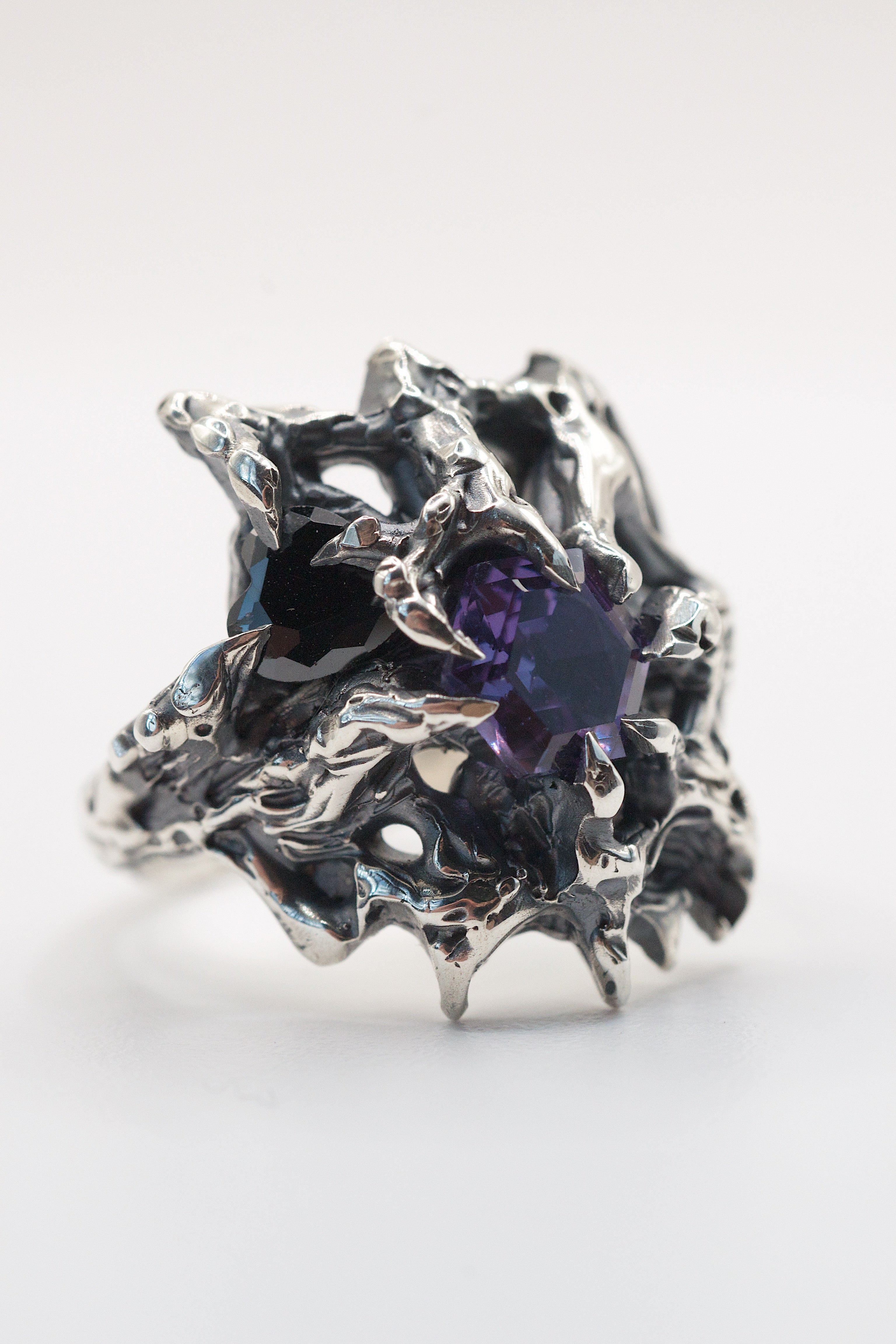 Brutalist silver ring with gothic claws, hexagon alexandrite, and heart-shaped cubic zirconia.