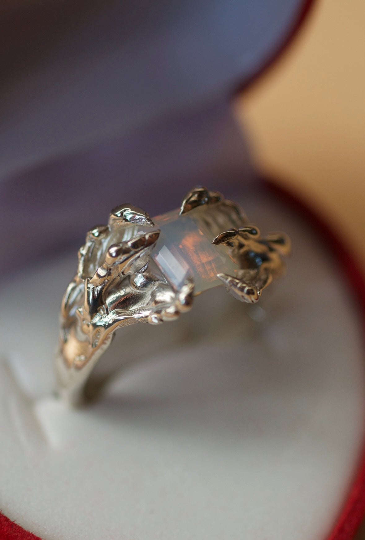 Lost wax carved ring with sterling silver and a milky opal in a ring box