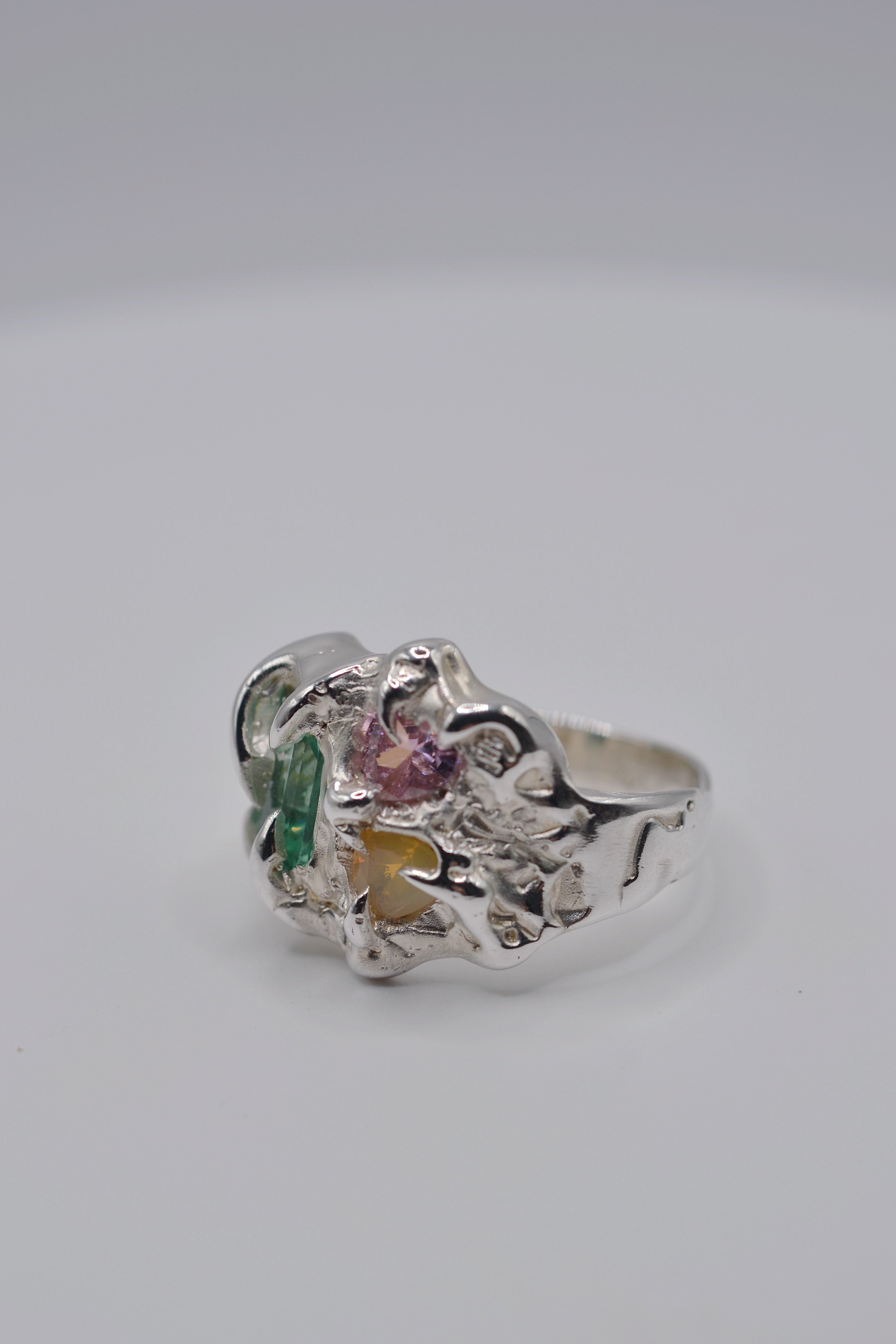 Detail shot of the Mirage. Organic handmade silver ring, wax carved and lost wax cast. Set with green tourmaline, pink heart cubic zirconia and milky yellow opal. Metal Bones Jewellery.