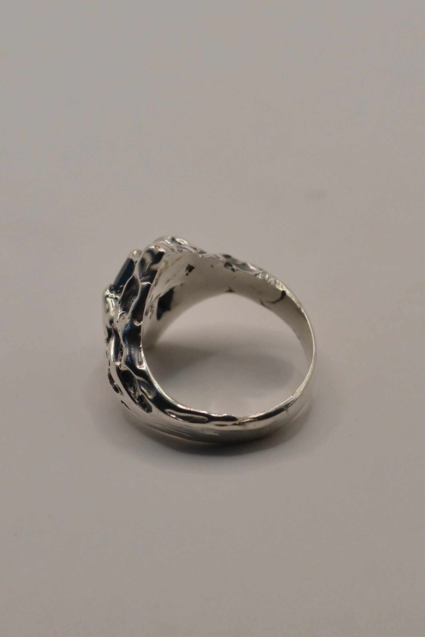 A handcrafted lost wax ring with a natural kite-cut topaz, exuding gothic romance and ethereal charm. Each piece is uniquely sculpted in recycled sterling silver for an elegant yet dark aesthetic.