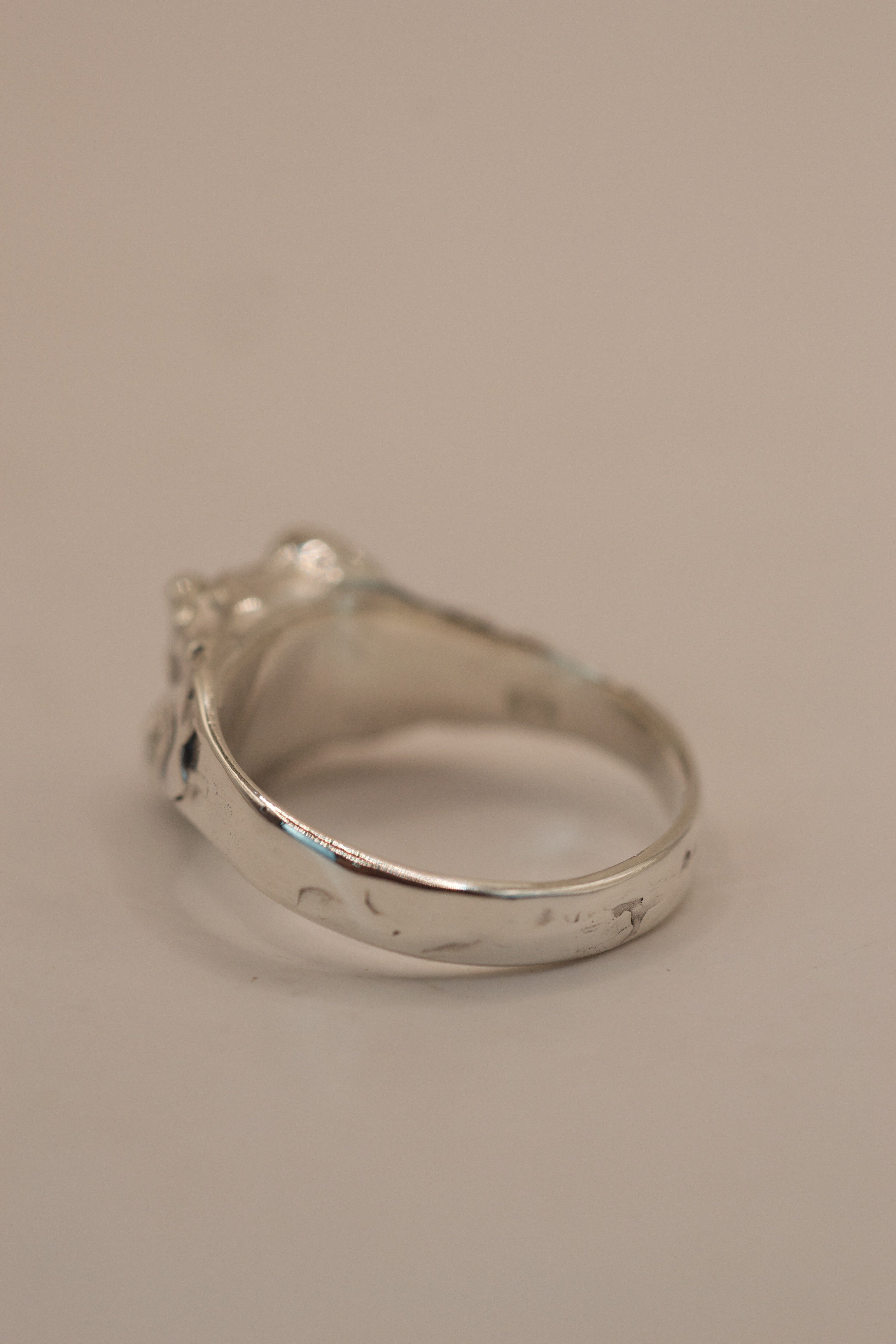 Gothic inspired alternative engagement ring crafted in sterling silver, handmade with the lost wax technique, featuring a pear cut moissanite.