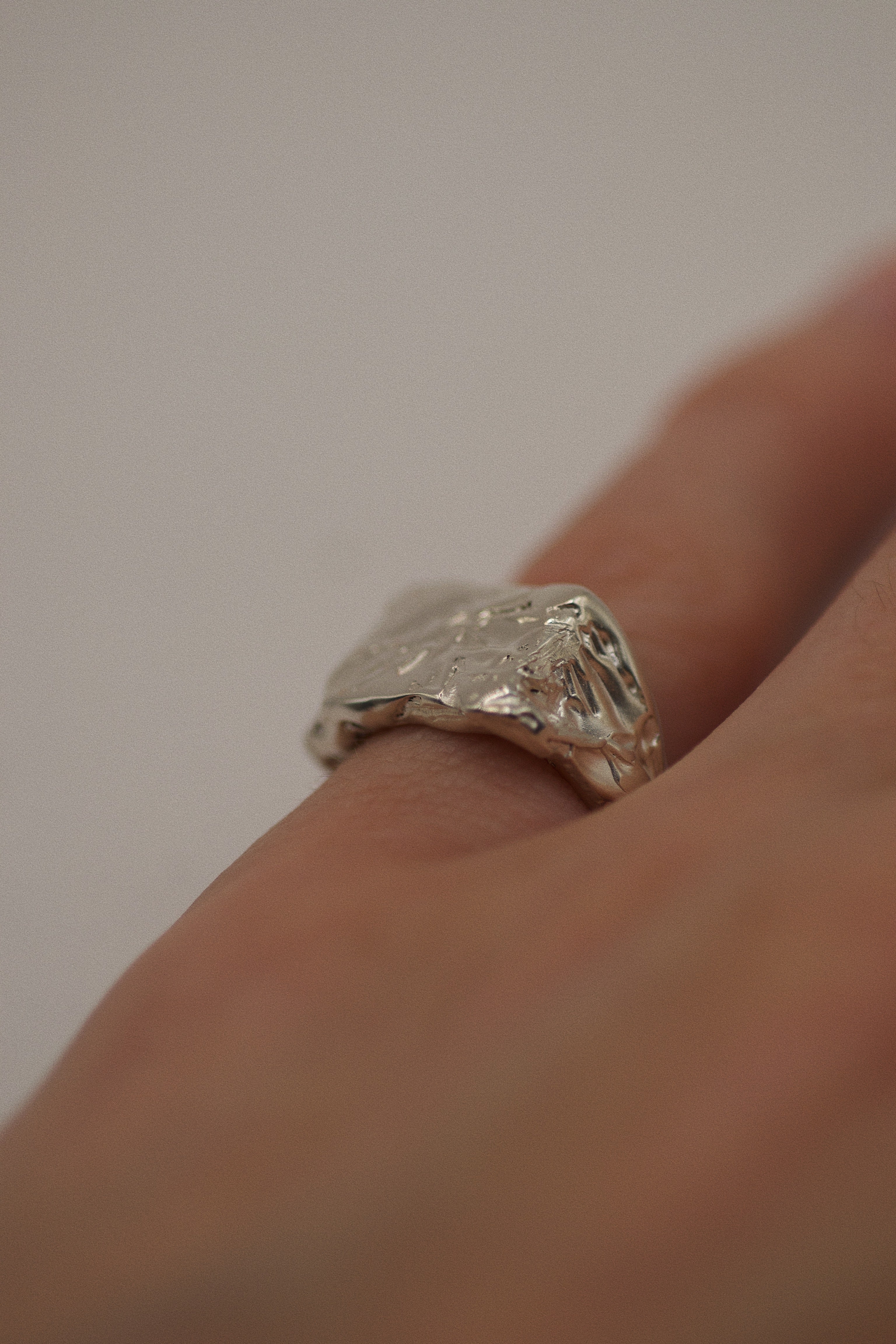 Handcrafted 925 sterling silver signet ring, made with lost wax casting, featuring deep sculpted ridges, chiseled edges, and a sharp, squared-off surface for a modern, raw aesthetic.