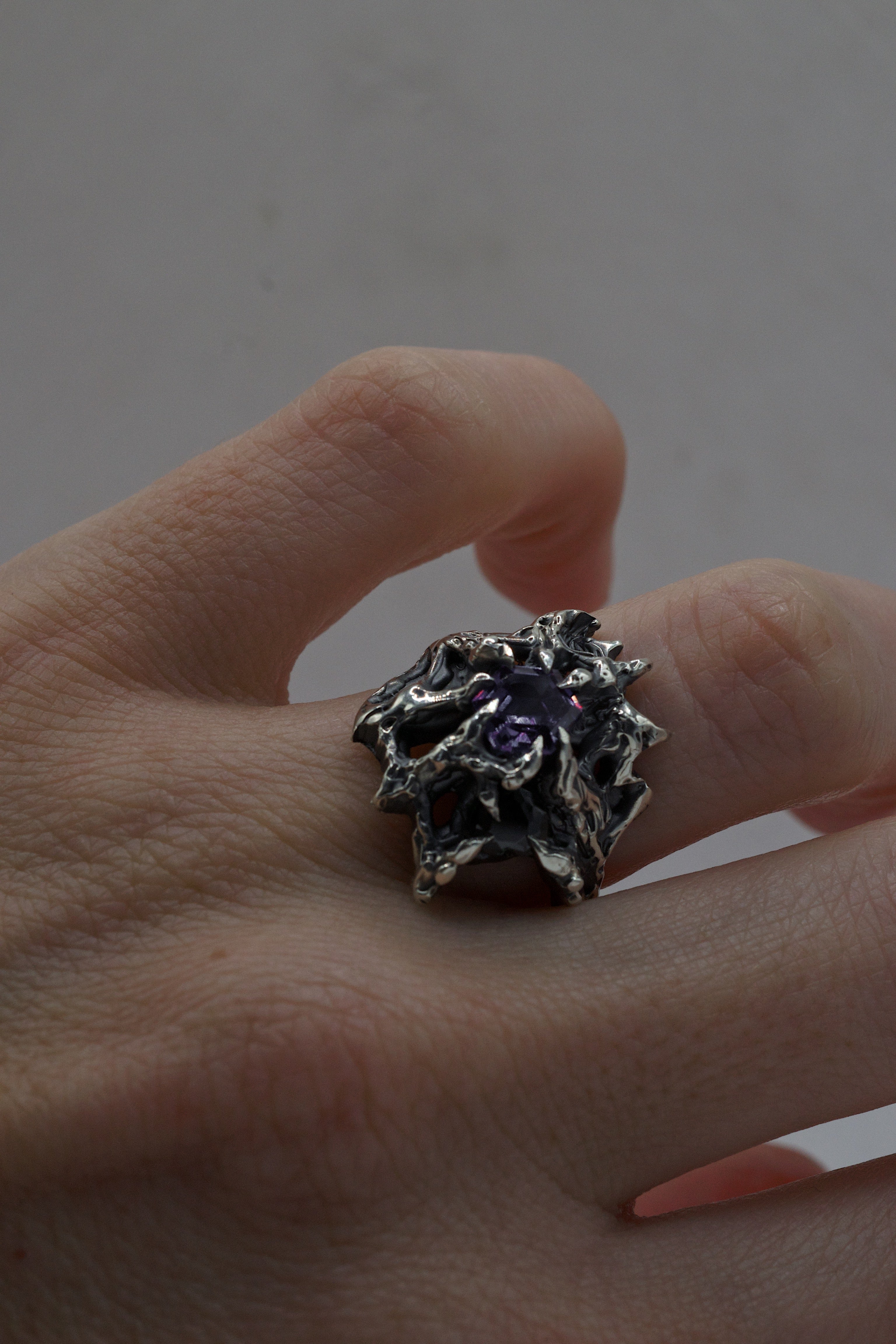 An artistic silver ring cast from wax, combining a geometric alexandrite with a romantic cubic zirconia heart.
