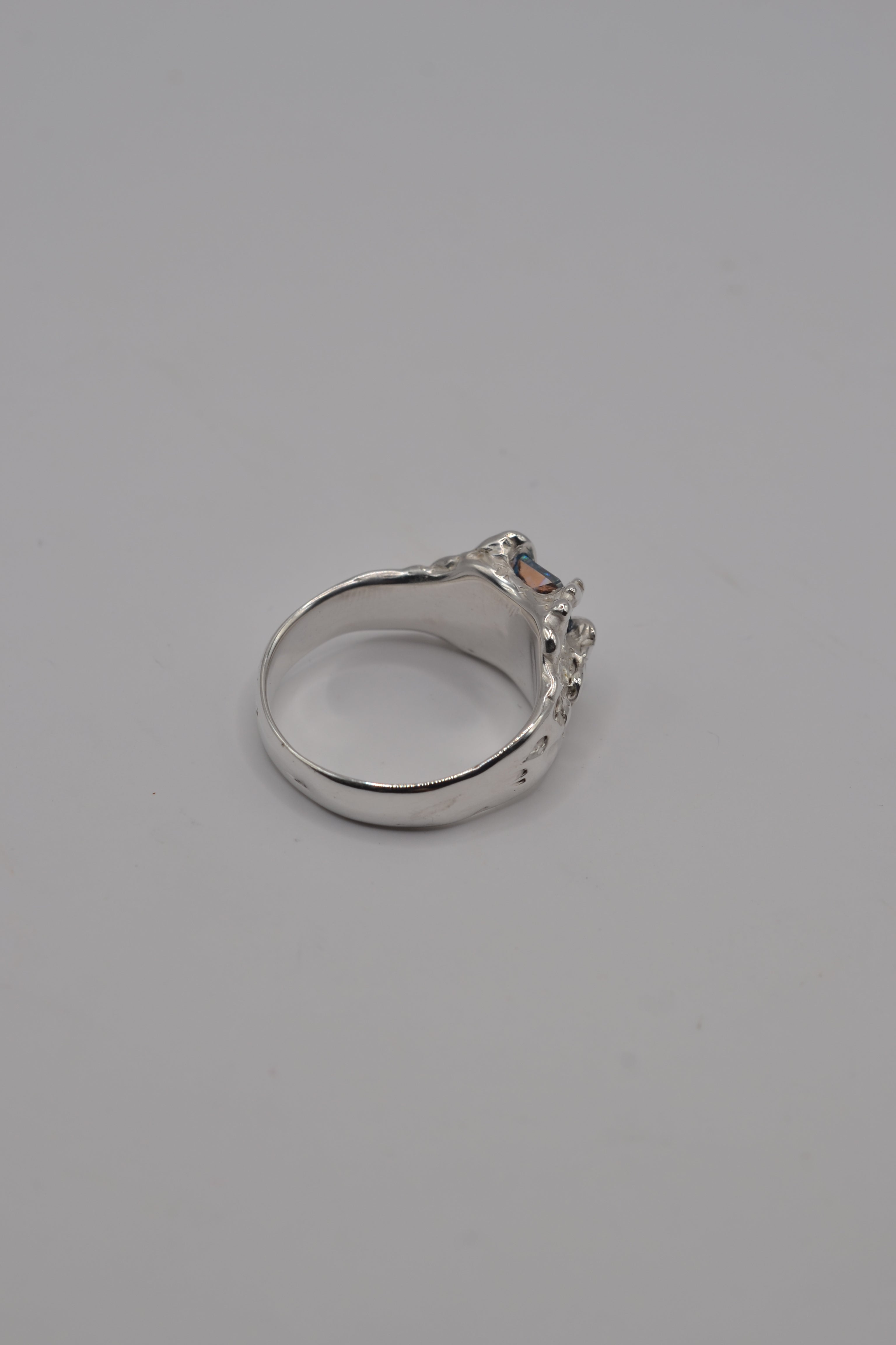 Handcrafted sterling silver ring made with lost wax casting, showing the smooth inner band and sculptural exterior.