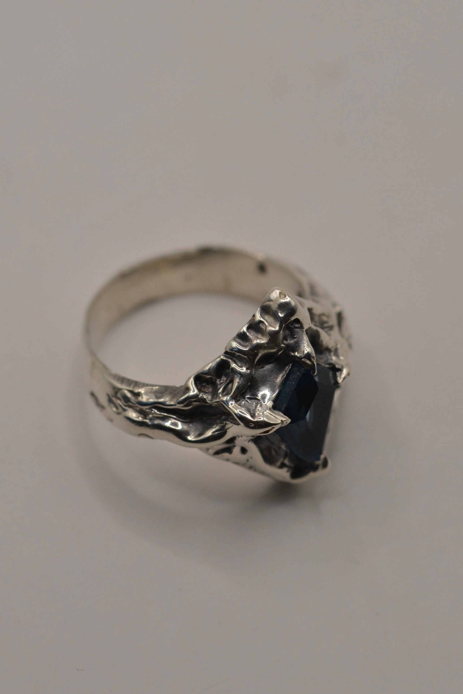 Sculpted using the lost wax method, this gothic-inspired silver ring features an ethereal kite-cut topaz, set in recycled sterling silver with darkened details for depth and dimension.