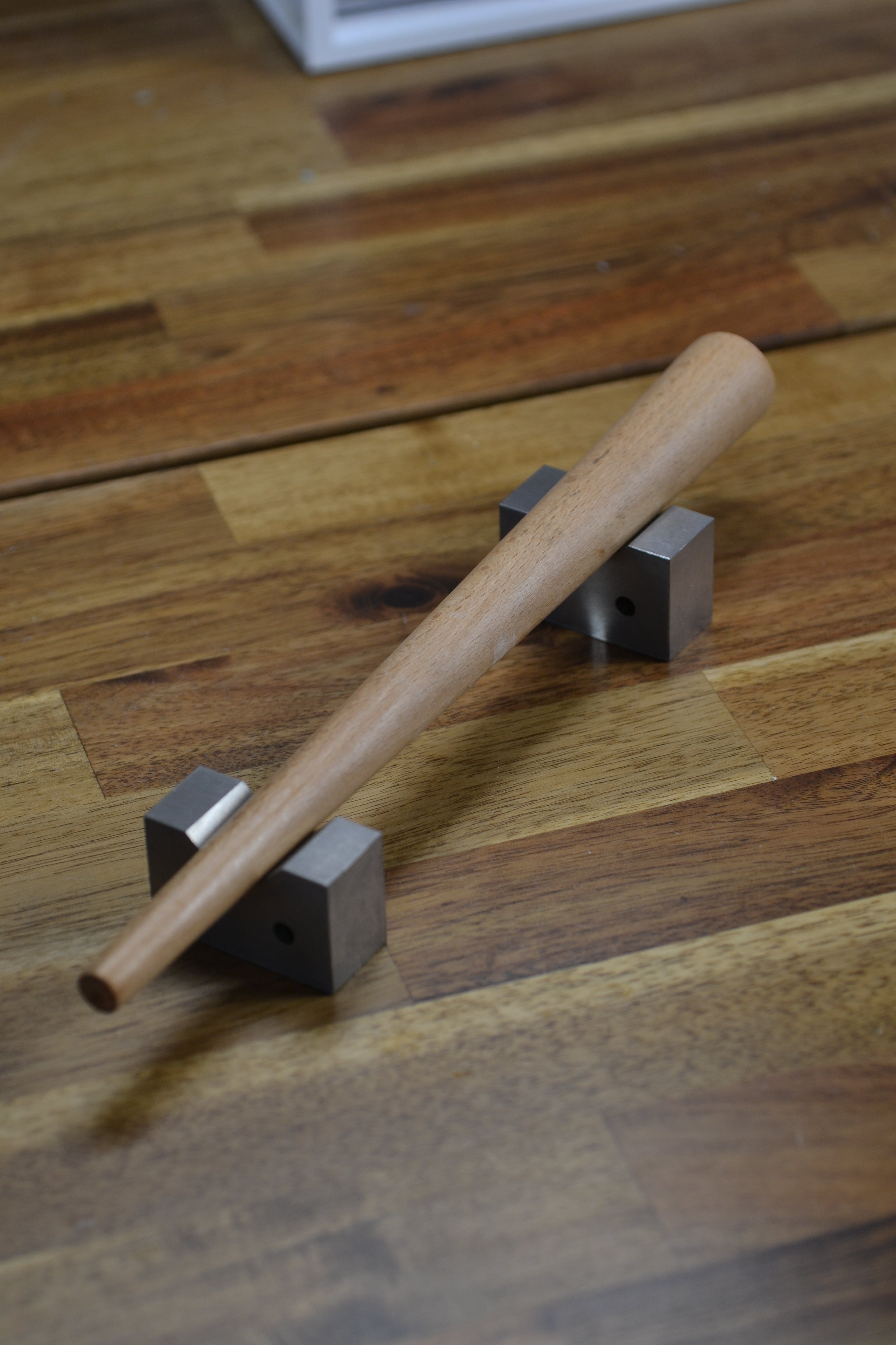 Ring mandrel resting on cast iron holders ready for wax carving and jewellery making.