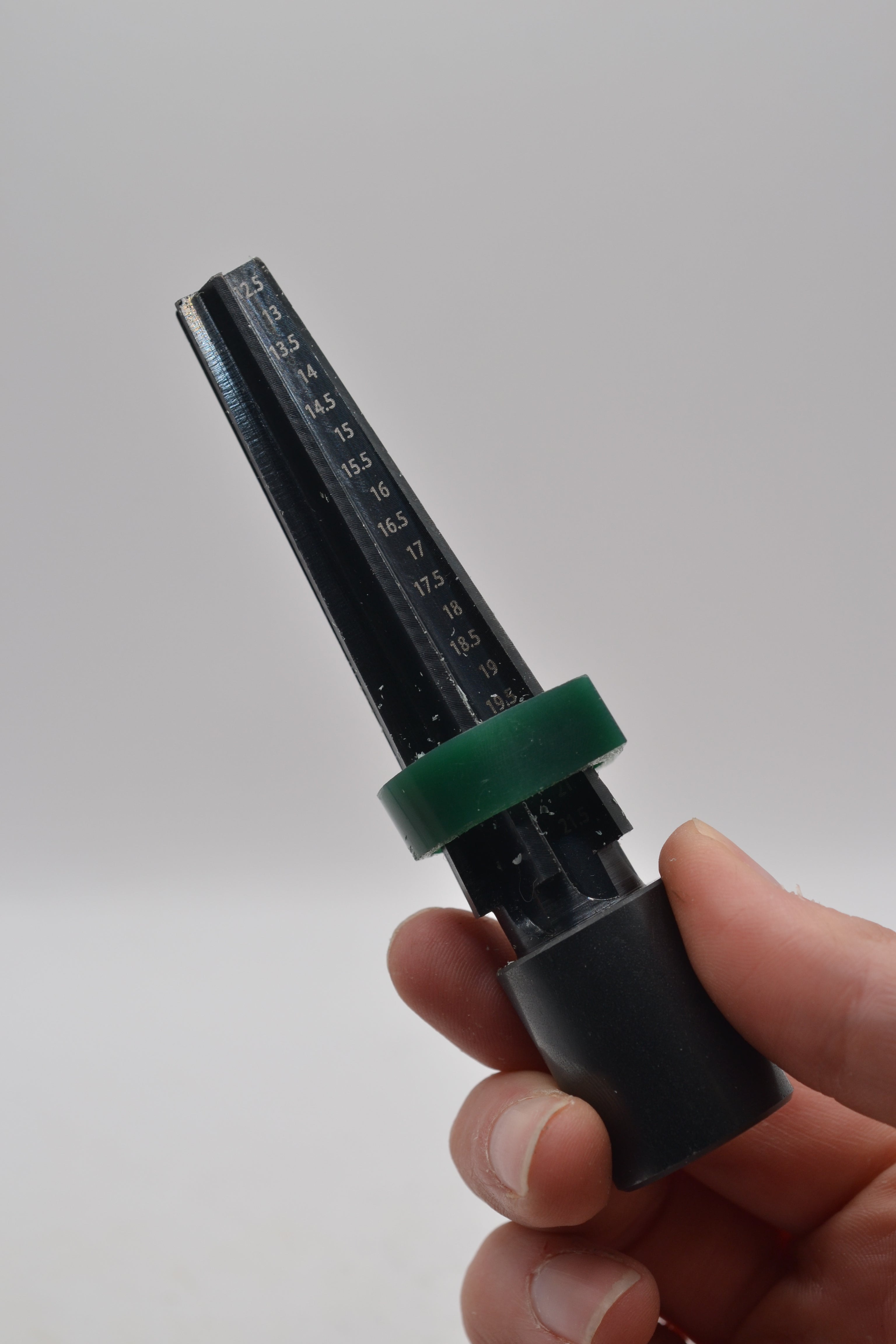 Close-up photo of a hand holding a wax carving mandrel
