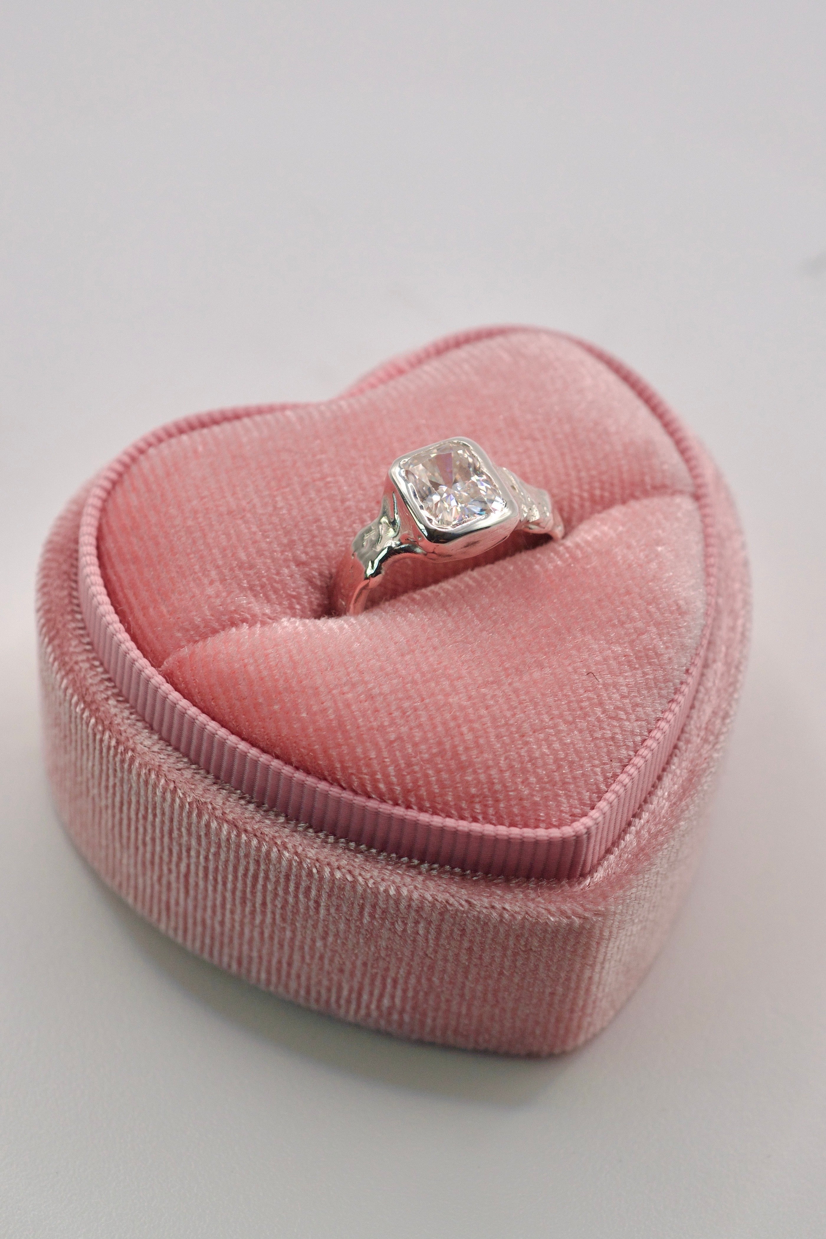 Handmade lost wax cast sterling silver ring with asymmetric textured molten band surrounding a radiant cut white moissanite, raw romantic alternative engagement ring made using the wax carving technique