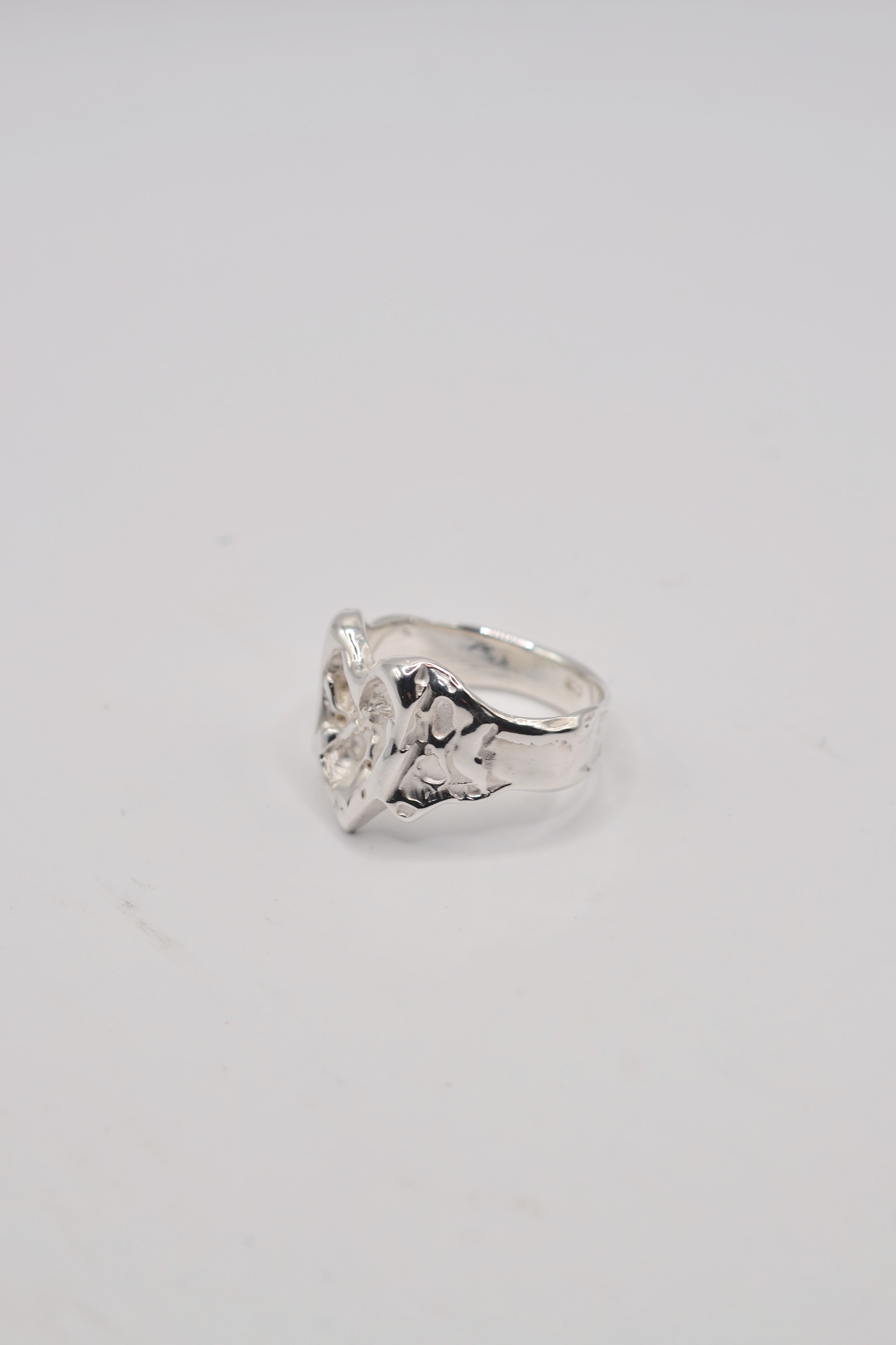 Front view of the Bleeding Heart Ring showing sculpted sterling silver heart with flowing vein detail handmade using the lost wax technique