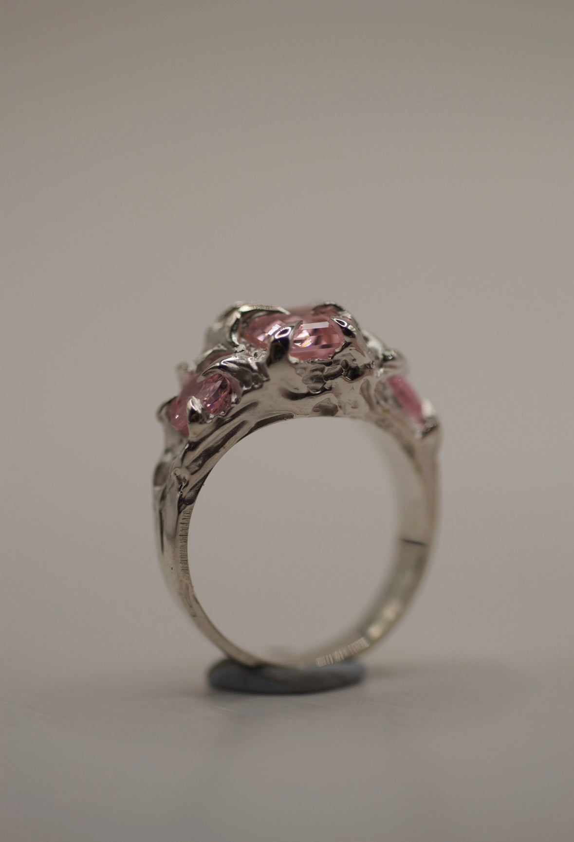 Sculptural non traditional engagement ring lost wax cast in sterling silver with pink lab-grown tourmaline and organic molten silver detail