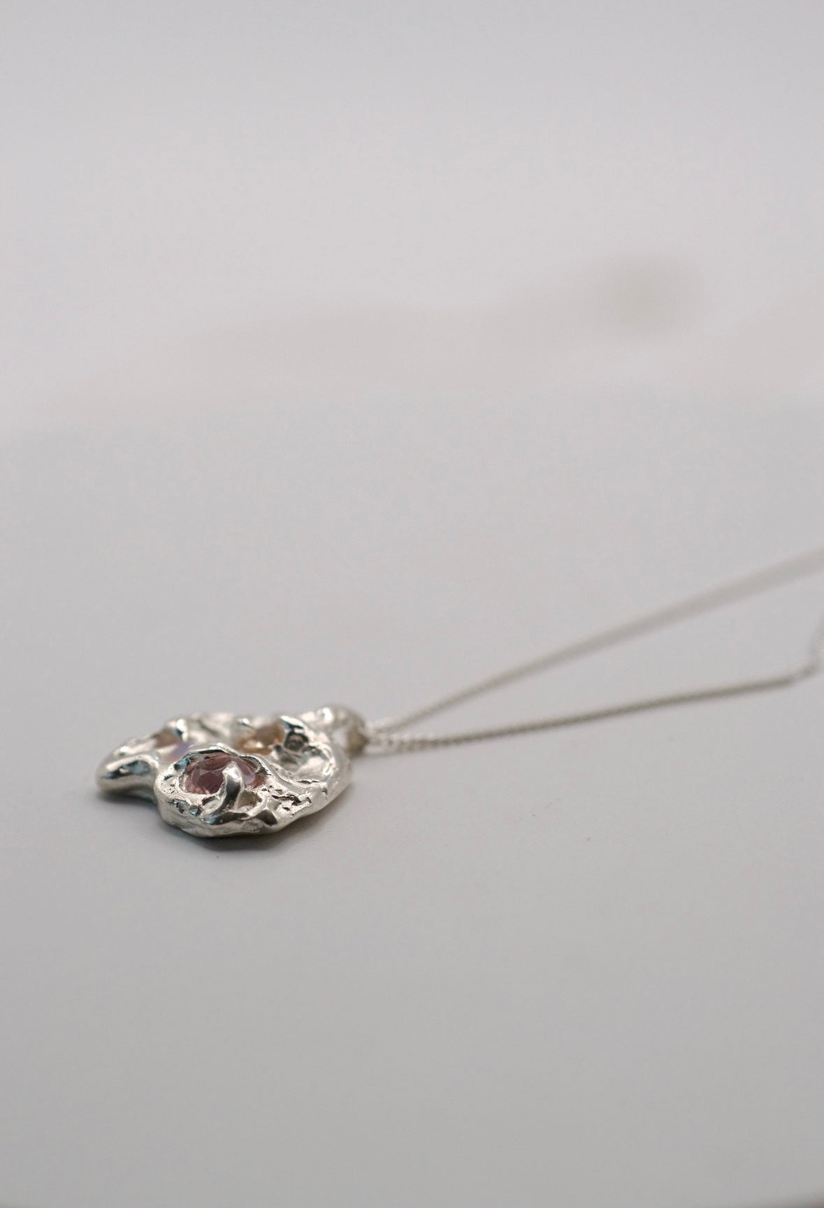 Sculptural handmade sterling silver necklace pendant lost wax cast with organic molten form and pastel gemstone detail
