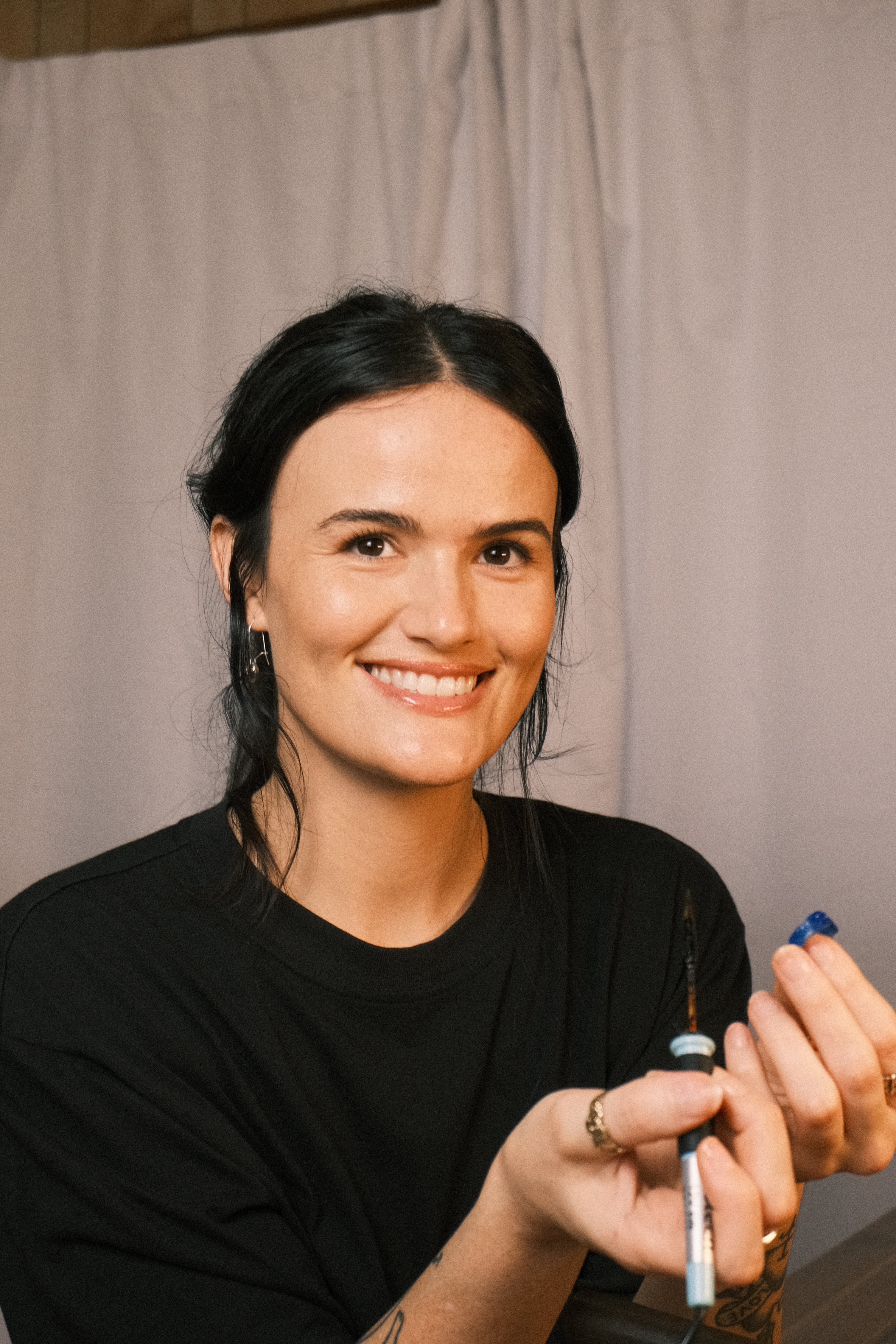 Cassandra Djodan jewellery maker and lost wax workshop teacher on the Sunshine Coast holding a wax carving tool, teaching students to make handmade silver jewellery