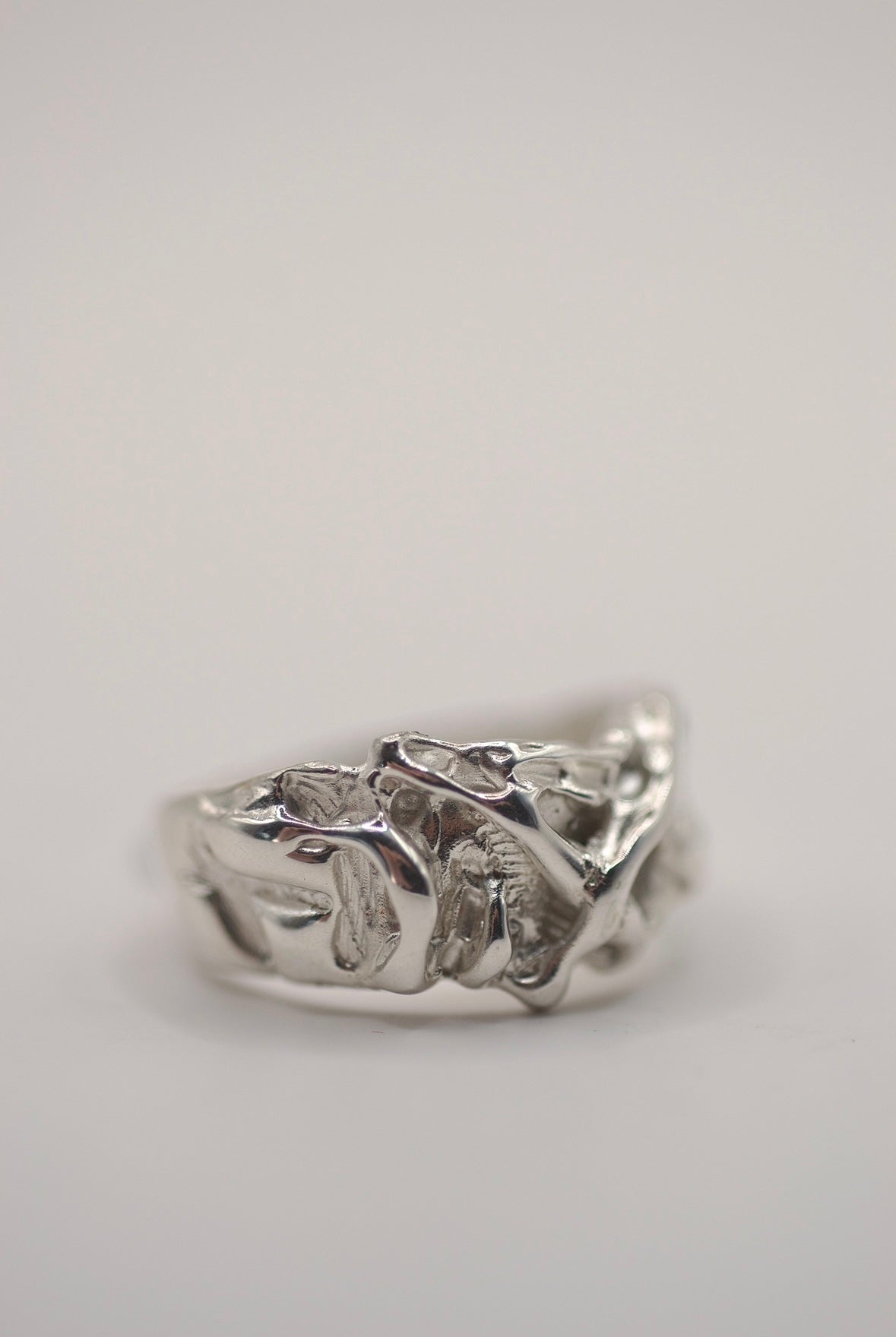 Side angle of the Cream Ring showing layered organic molten sterling silver texture handmade using the lost wax casting technique