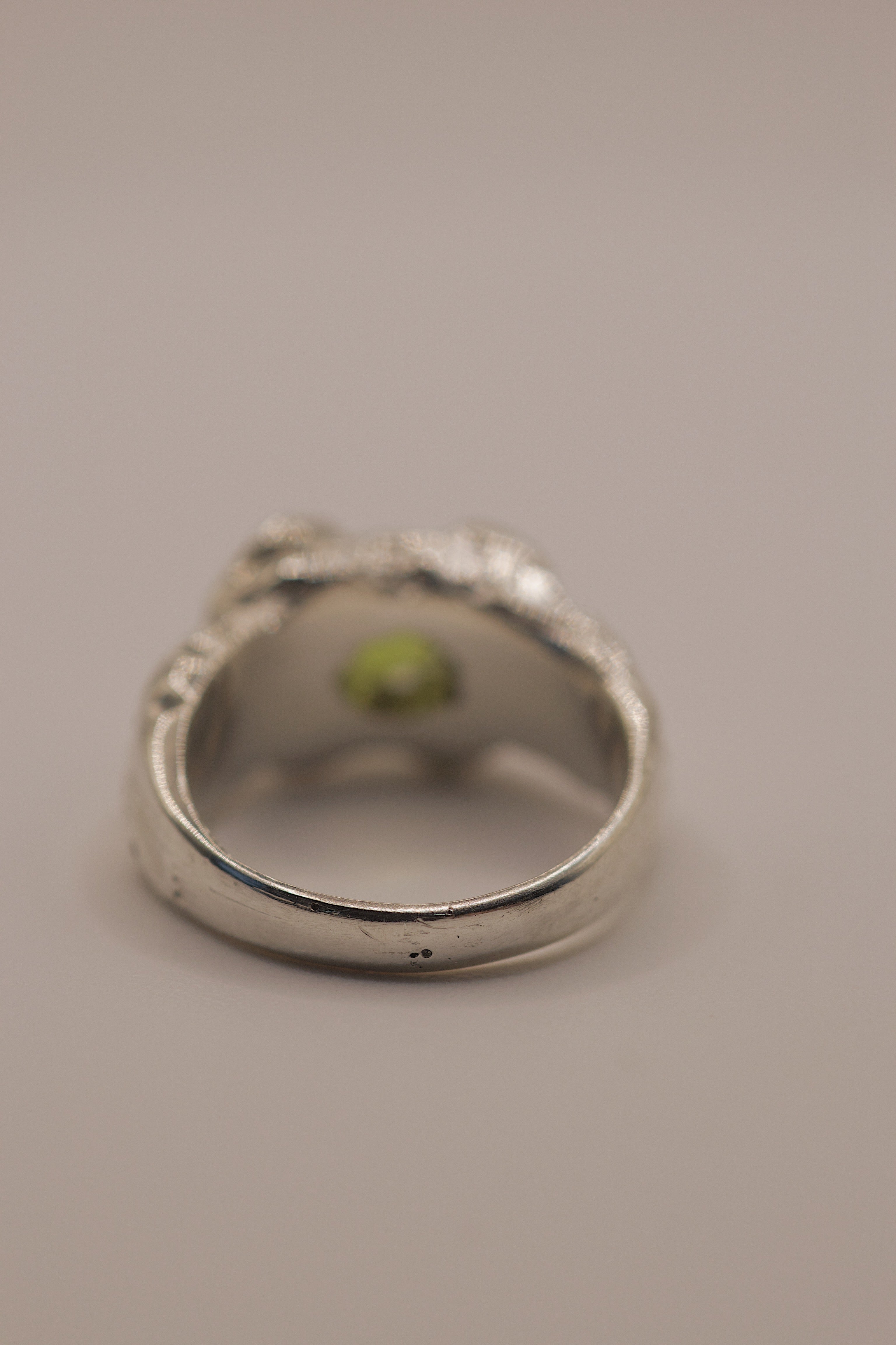 Another angle of the Fern Ring showing cushion cut peridot within organic textured molten sterling silver handmade using the lost wax technique