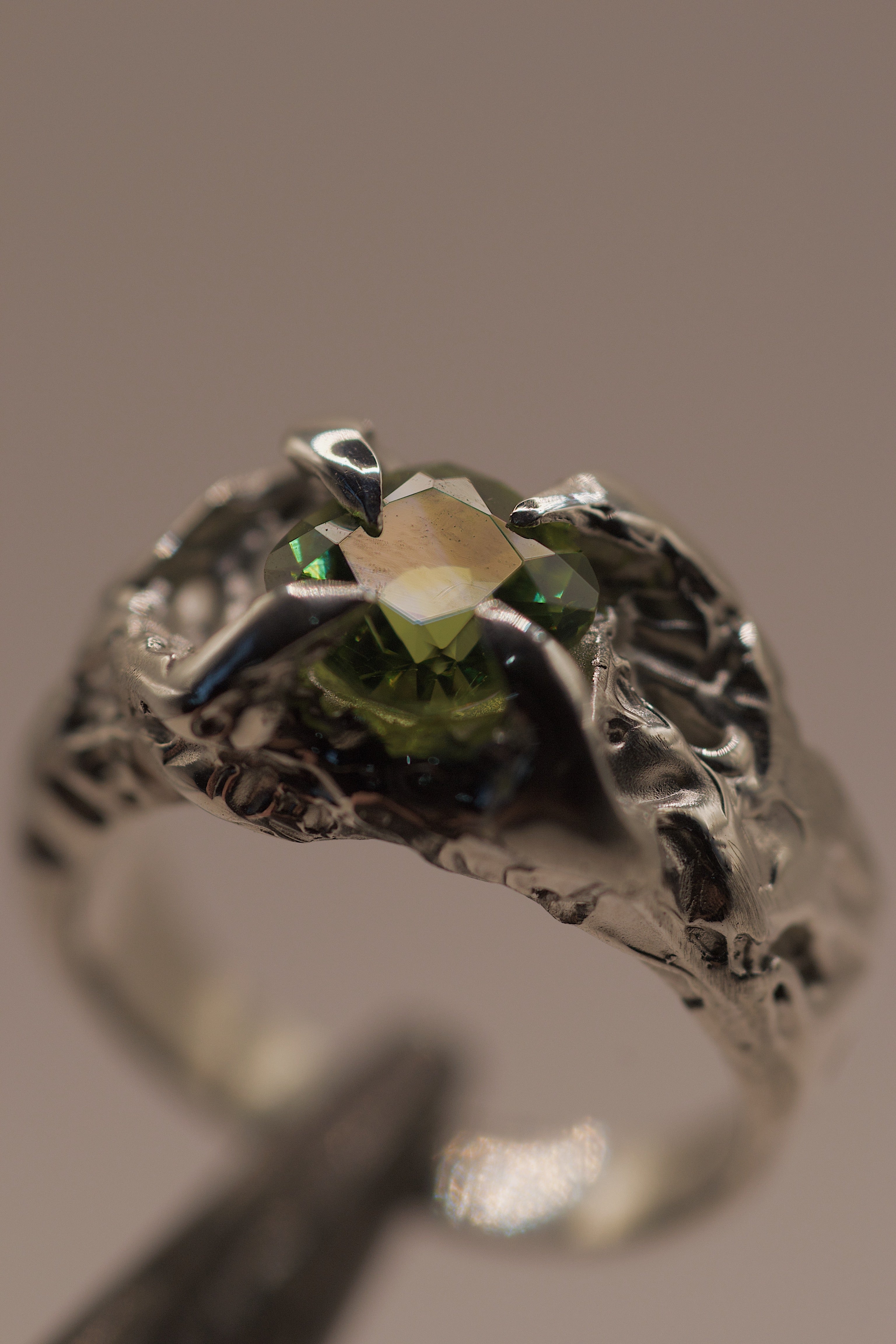 Handmade lost wax cast sterling silver ring with cushion cut lab-grown peridot set within enchanting organic molten silver with textured dimensional shoulders, fairytale alternative ring made using the wax carving technique