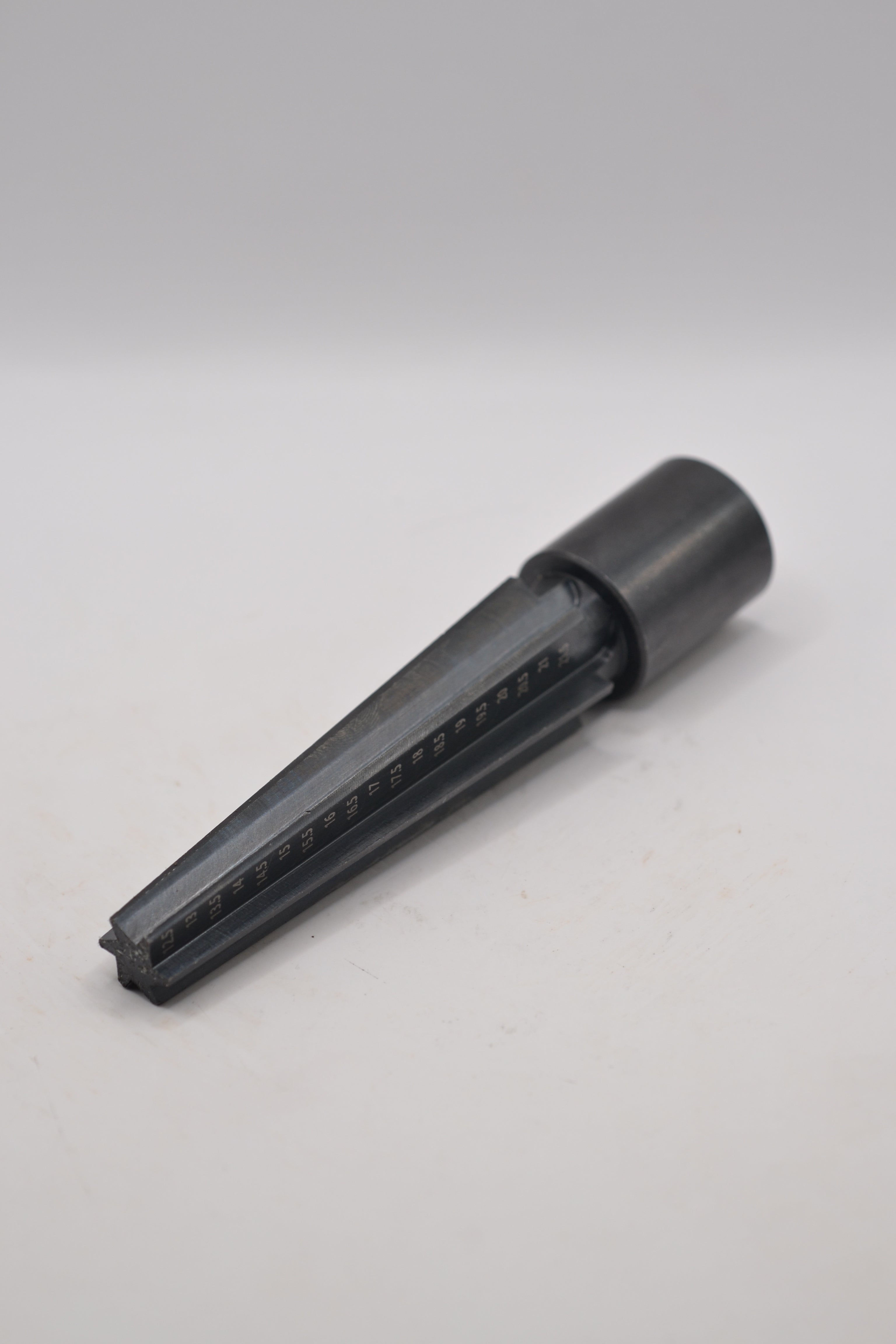 metal black wax carving mandrel on white surface