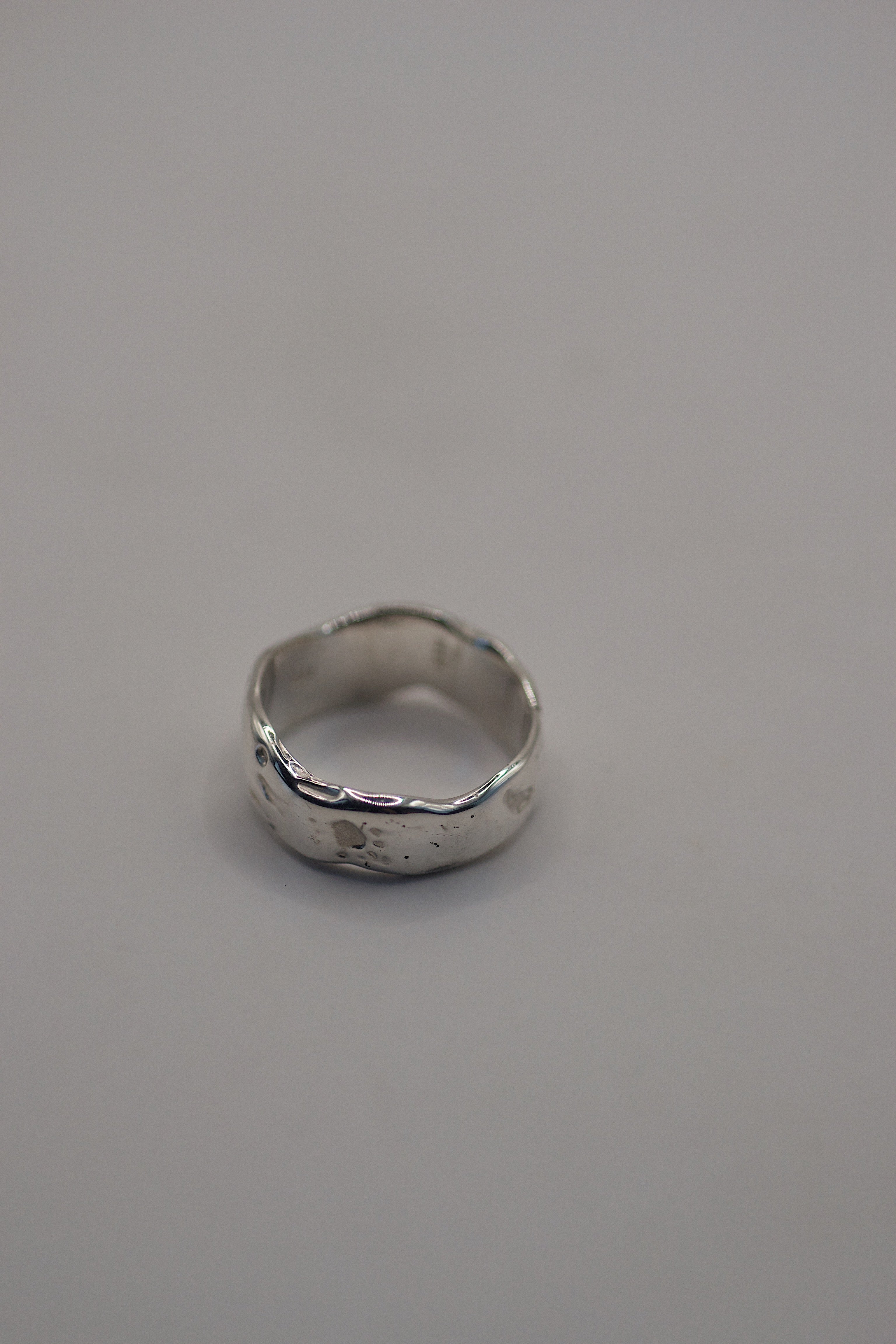 Front view of the Molten Ring showing organic flowing sterling silver band with molten texture handmade using lost wax casting