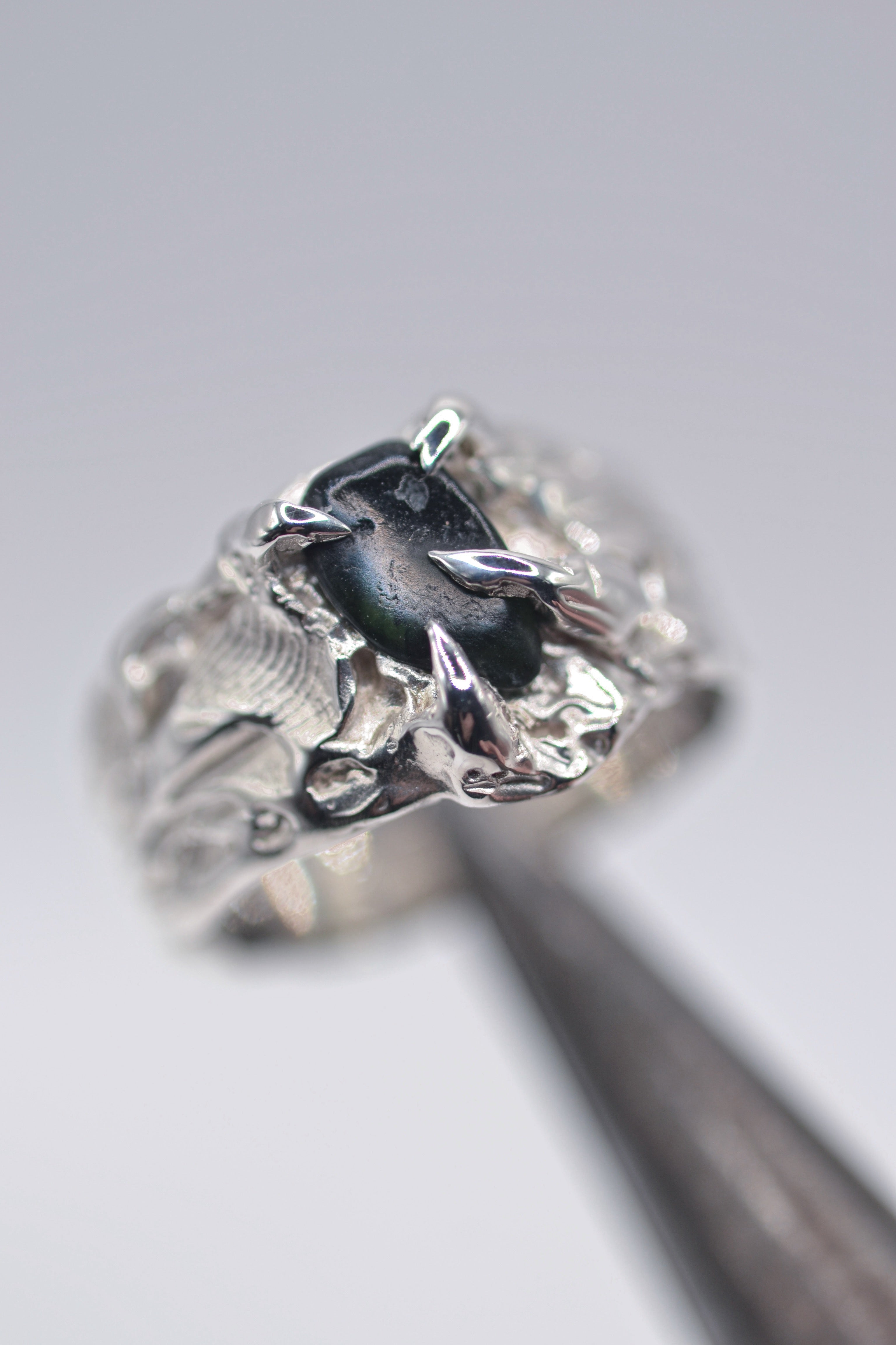 Handmade lost wax cast sterling silver rattlesnake ring with organic sculptural form and dark alternative detail made using the wax carving technique