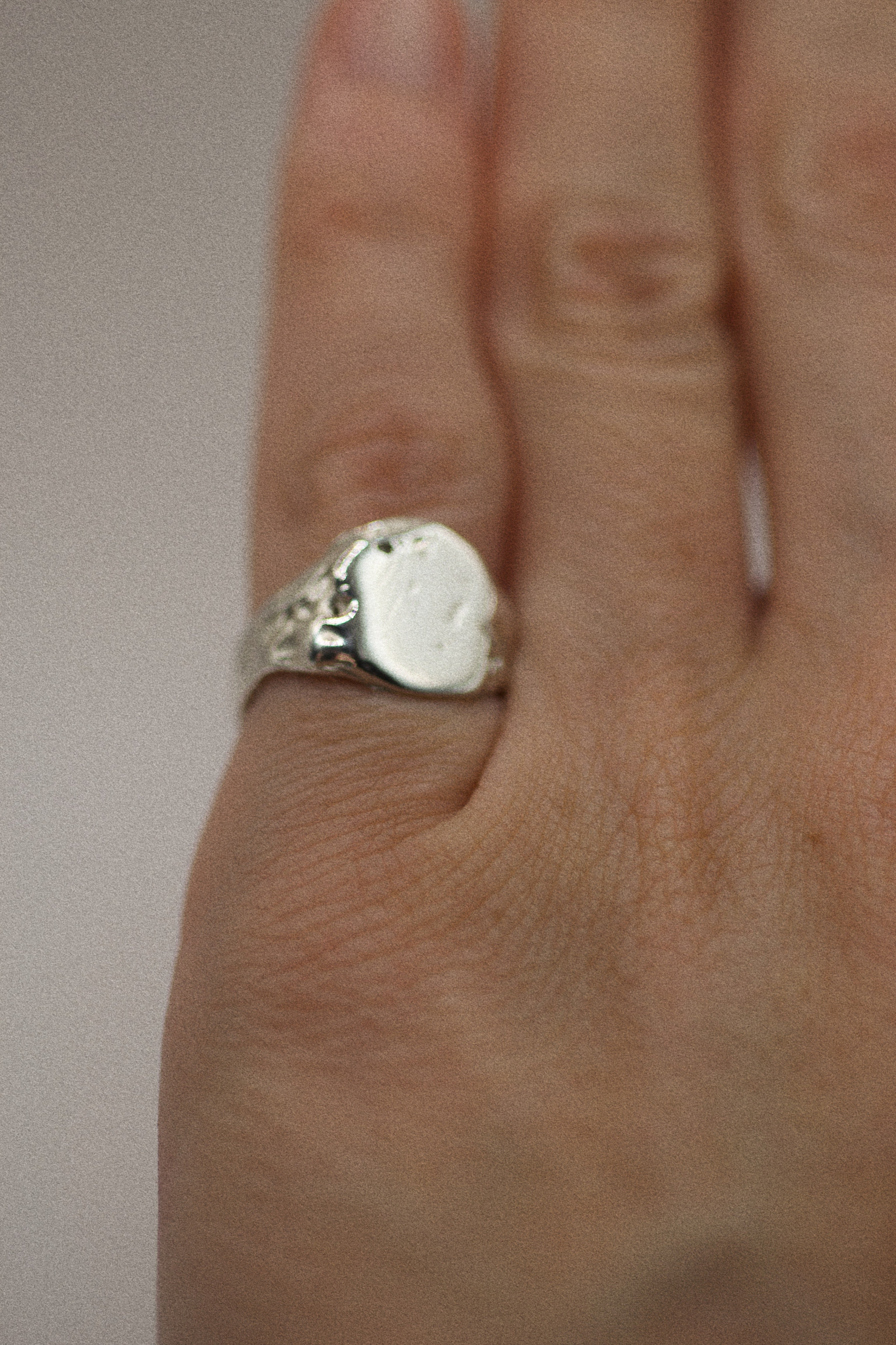 Side angle of the Raw Ring showing textured recycled sterling silver signet form handmade using lost wax casting technique