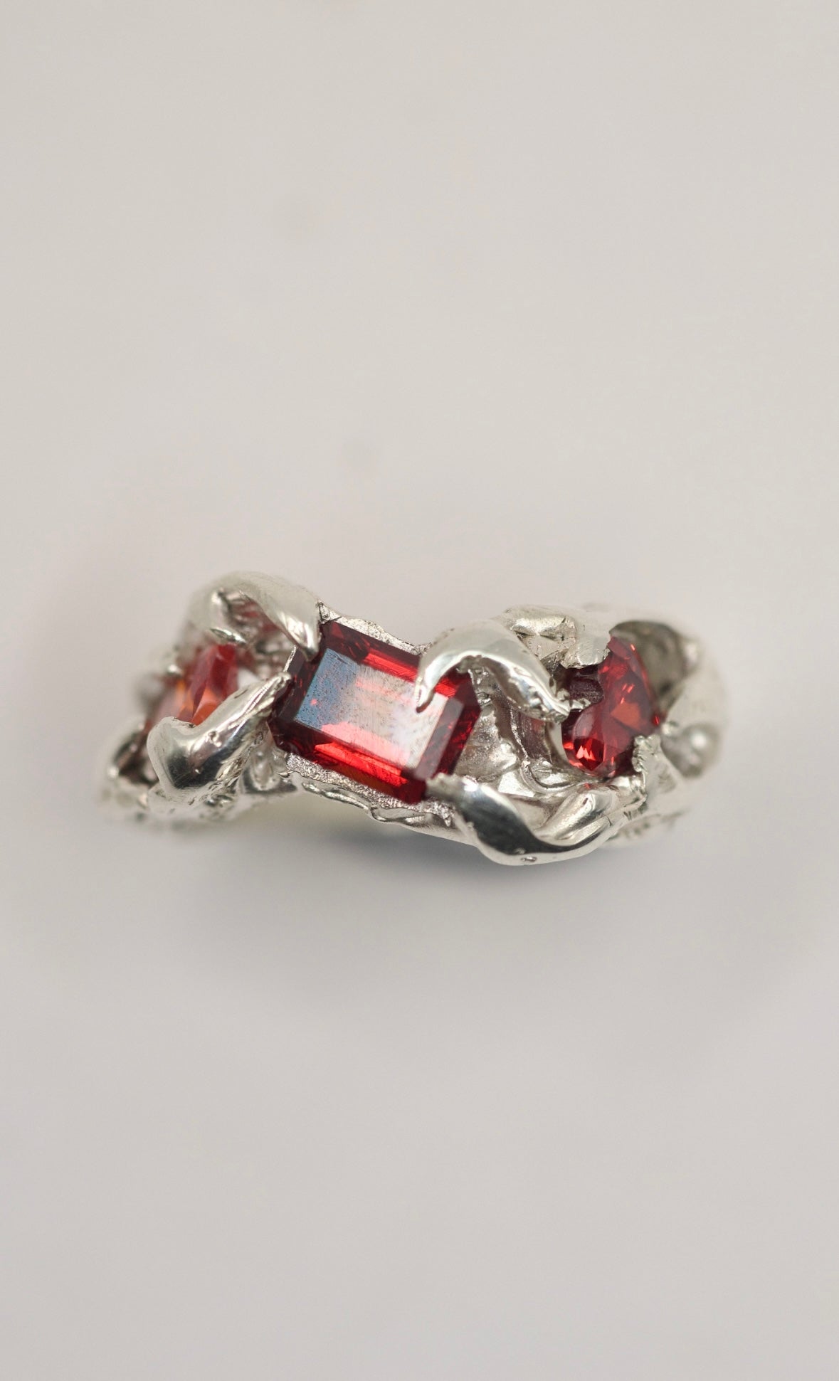 Handmade lost wax cast sterling silver ring with red garnet and heart cubic zirconia embedded in flowing organic silver, raw romantic alternative ring made using the wax carving technique