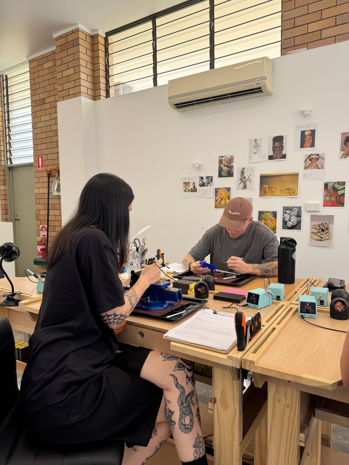 Two people wax carving jewellery at Metal Bones creative studio in Yandina on the sunshine coast