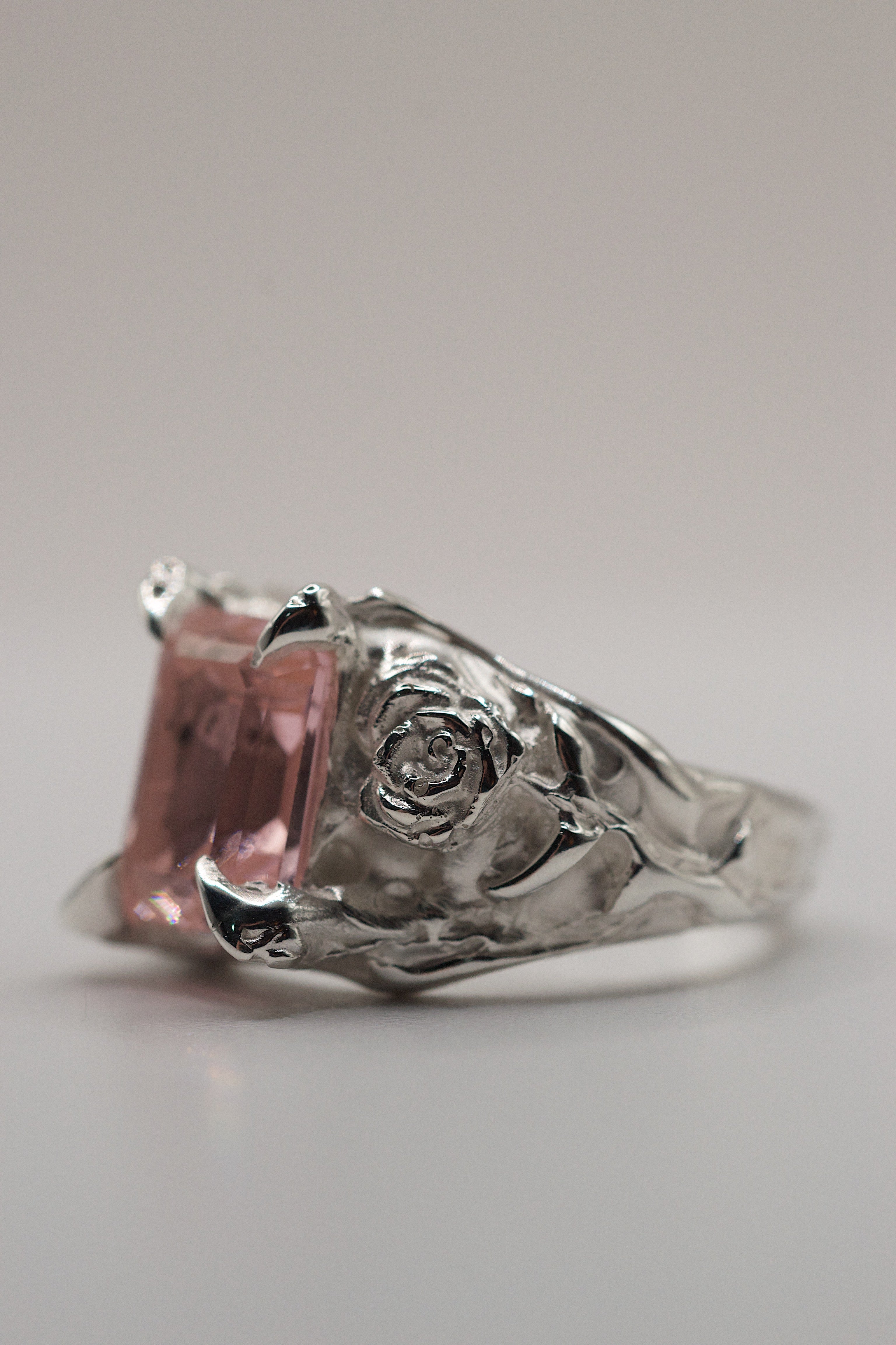 Handmade lost wax cast sterling silver ring with sculpted rose petals and flowing molten silver surrounding a pink lab-grown tourmaline, romantic alternative engagement ring made using the wax carving technique