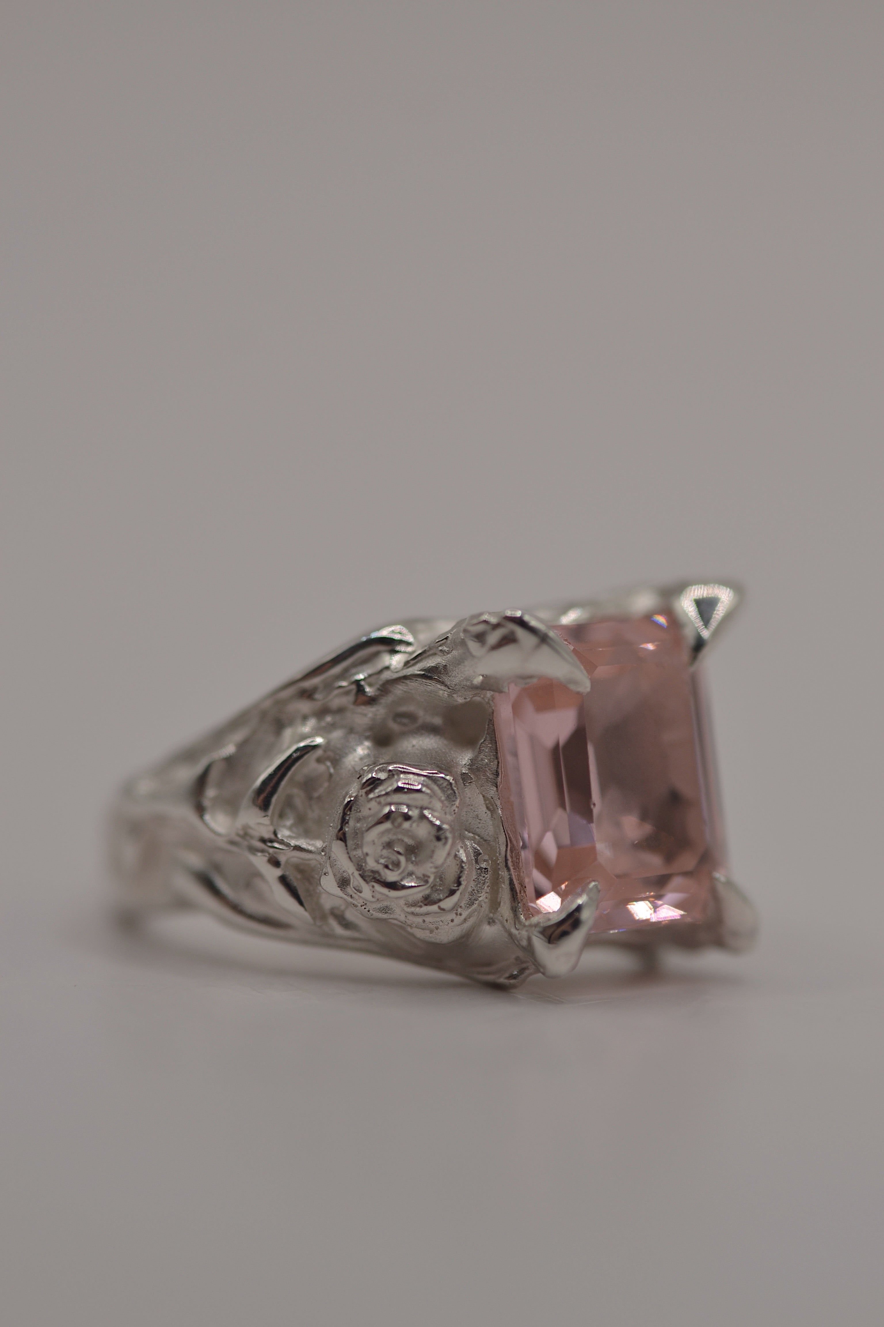 Lost wax cast silver Rosabelle Ring worn on hand with pink tourmaline and sculpted rose petal detail in recycled sterling silver