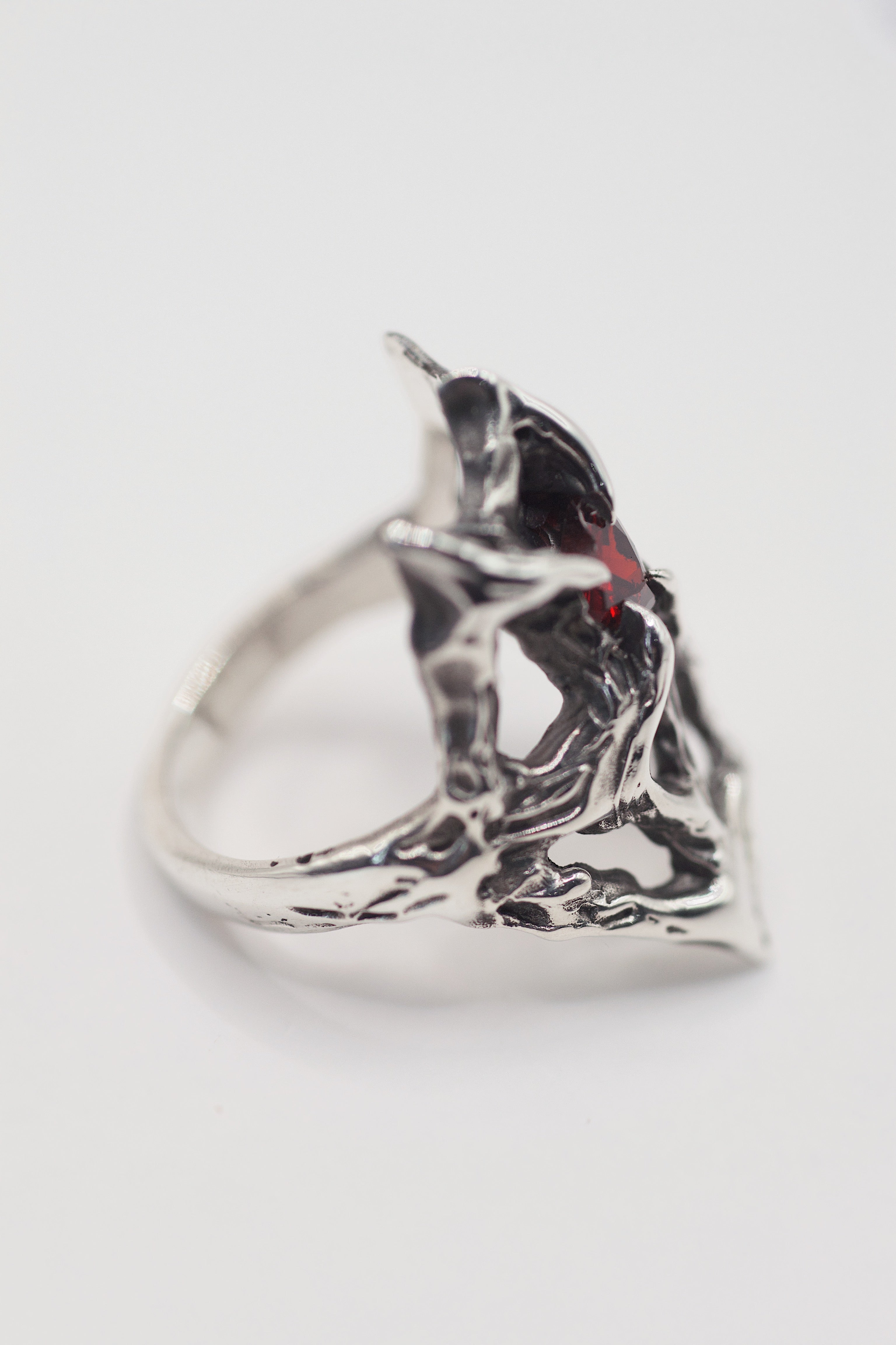 Side profile of the Scarlet Ring showing dramatic height of the intricate darkened silver web structure handmade using lost wax casting