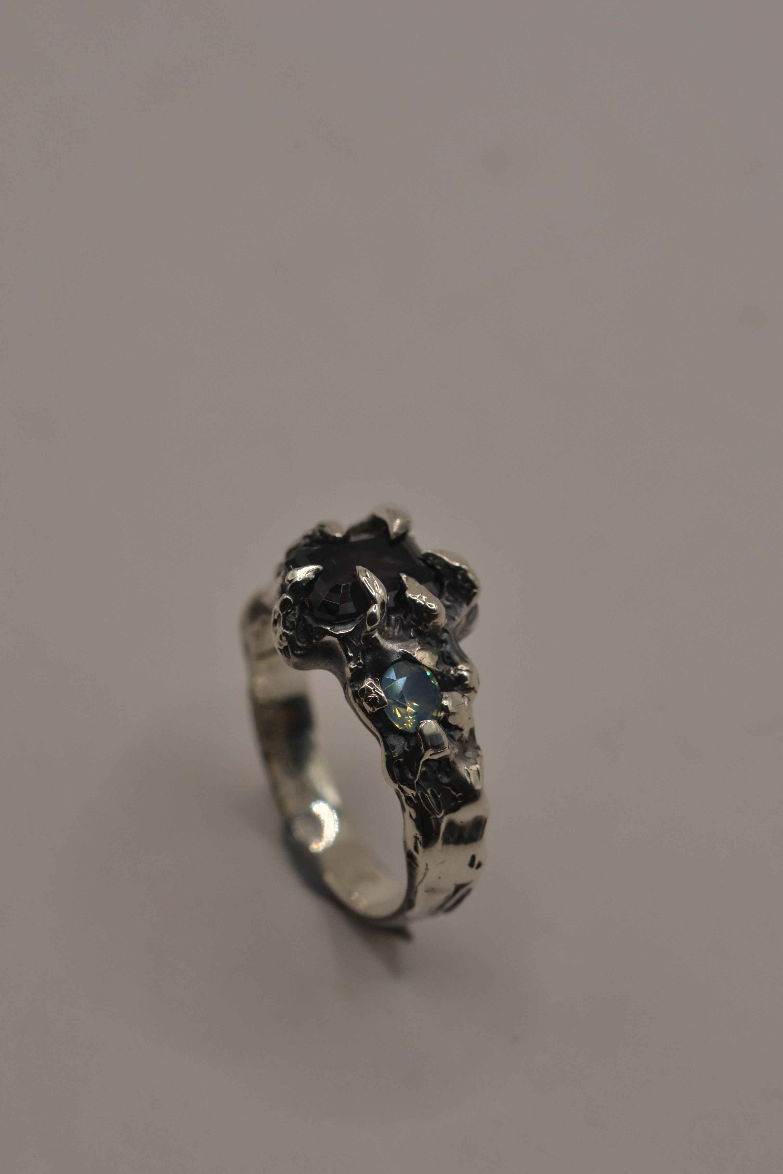 Side angle of the Silhouette Ring showing darkened recycled sterling silver band with sculptural claw detail handmade using lost wax casting