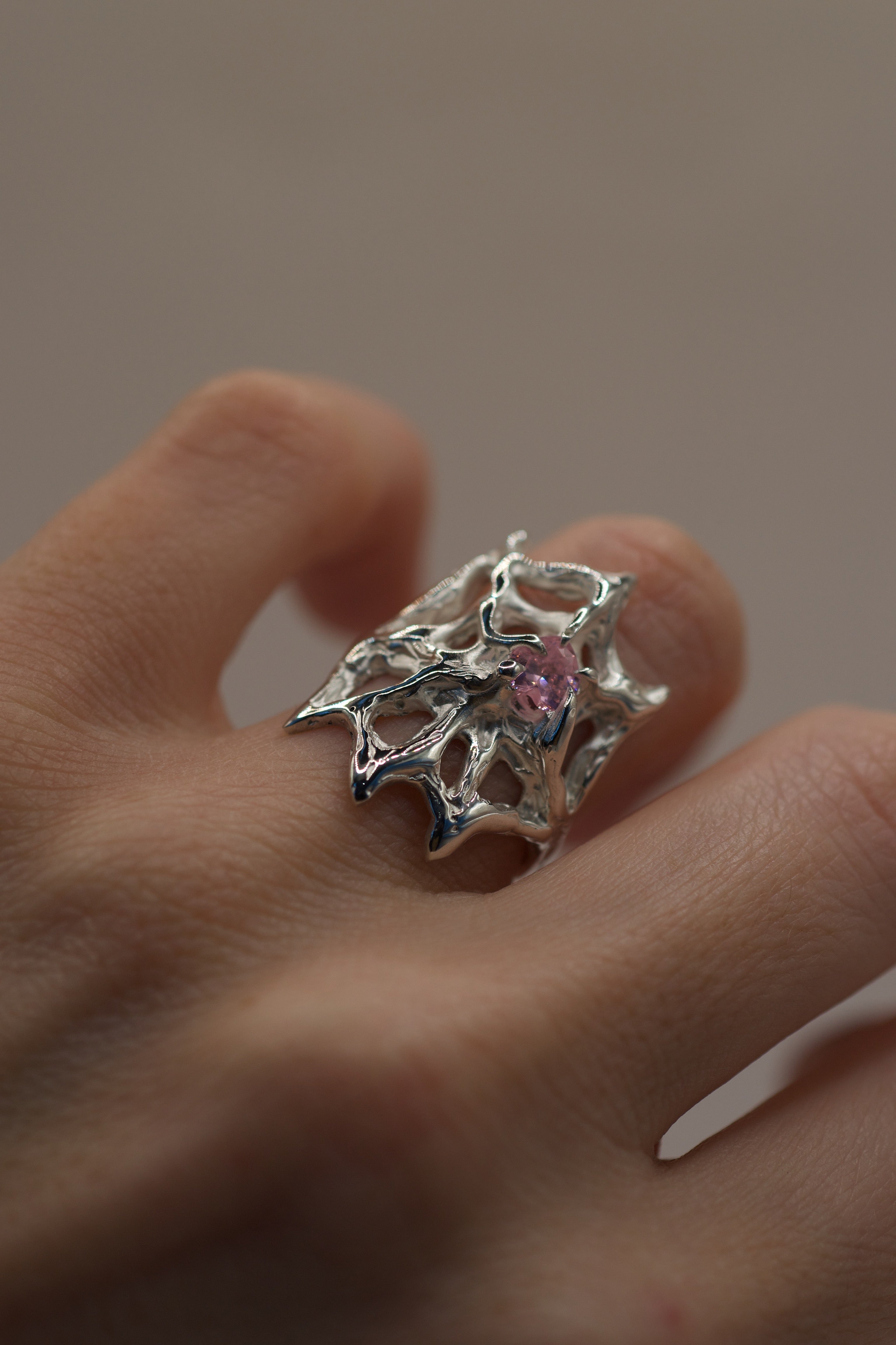 Another angle of the Silk Ring worn on hand showing organic flowing sterling silver web structure and pink heart stone handmade using the lost wax technique