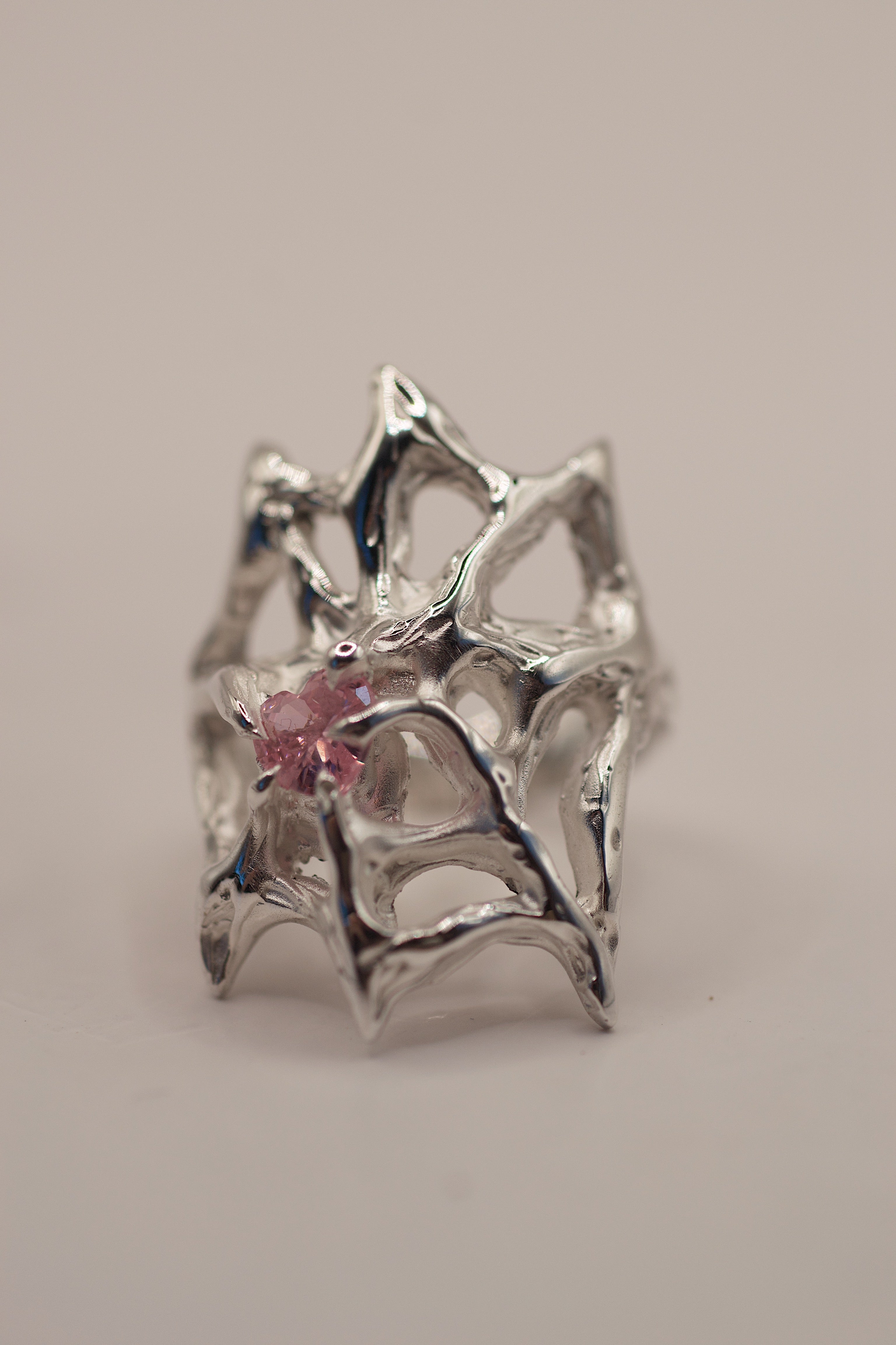 Handmade lost wax cast sterling silver ring with flowing web structure holding a pink heart cubic zirconia, feminine gothic alternative ring made using the wax carving technique