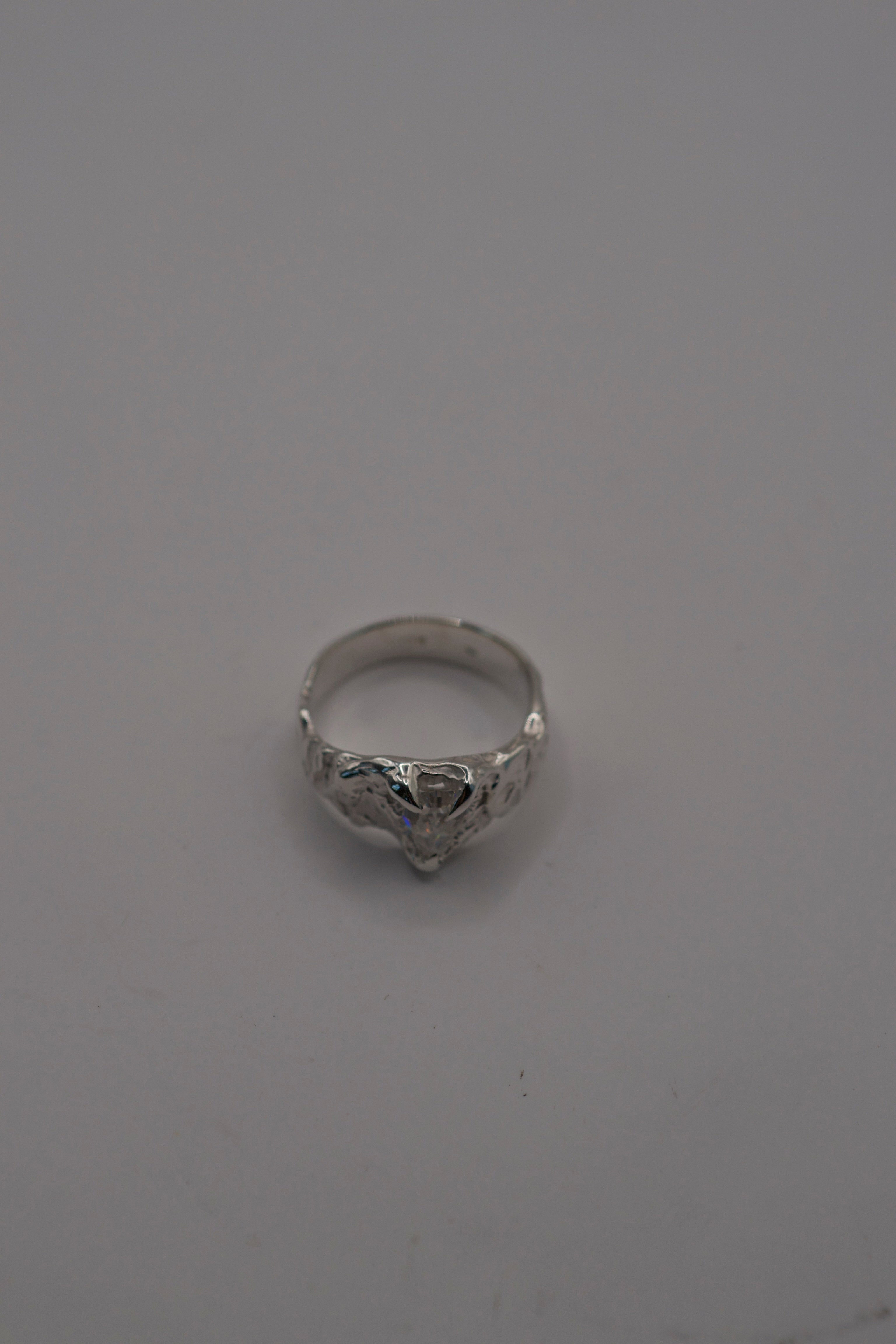 Lost wax cast silver Til Death Ring worn on hand non diamond alternative engagement ring with kite cut moissanite and organic textured sterling silver band