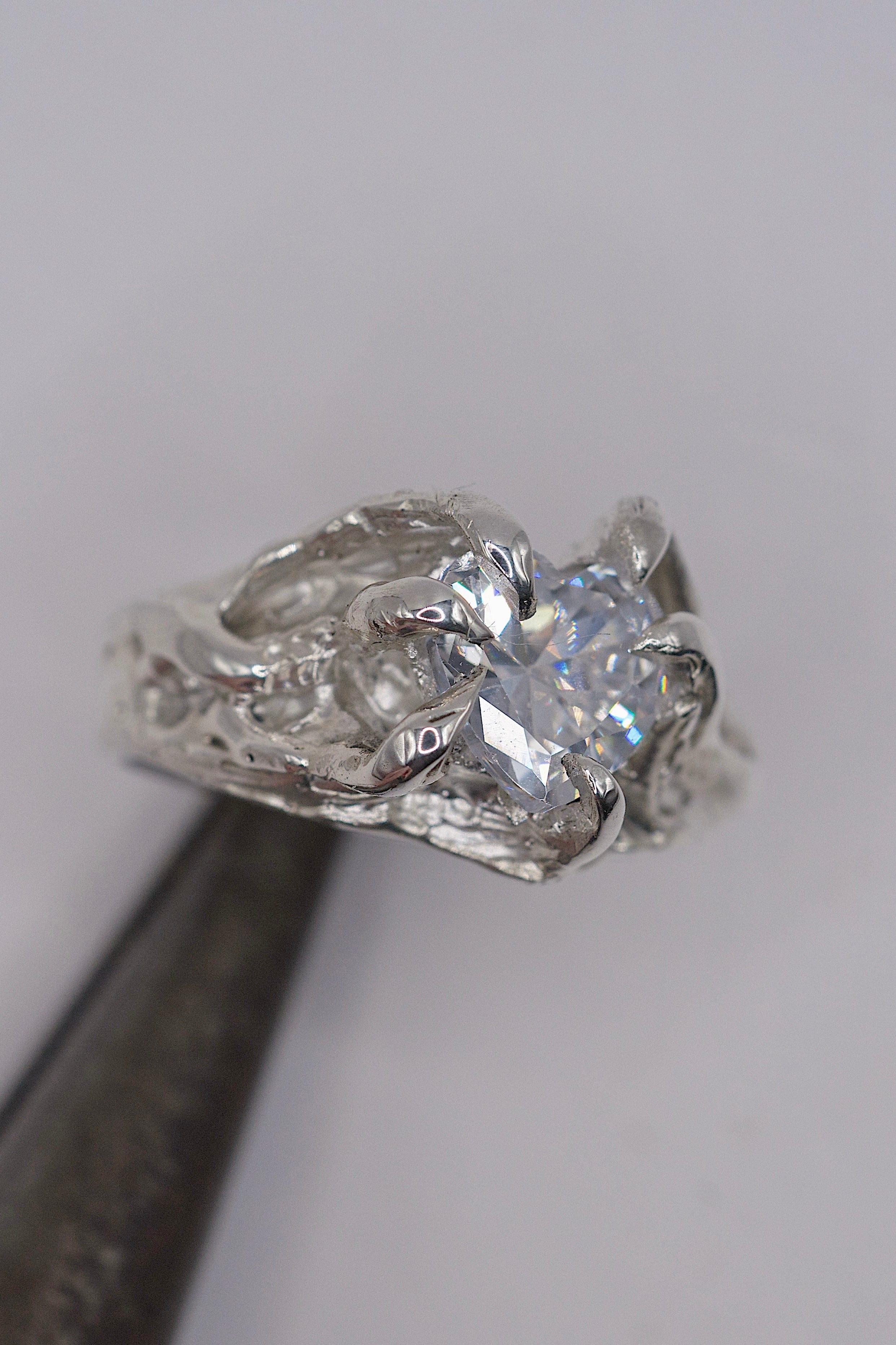 Close up of the Valentine Ring showing large heart cubic zirconia set within six organic molten sterling silver claws handmade using the lost wax technique