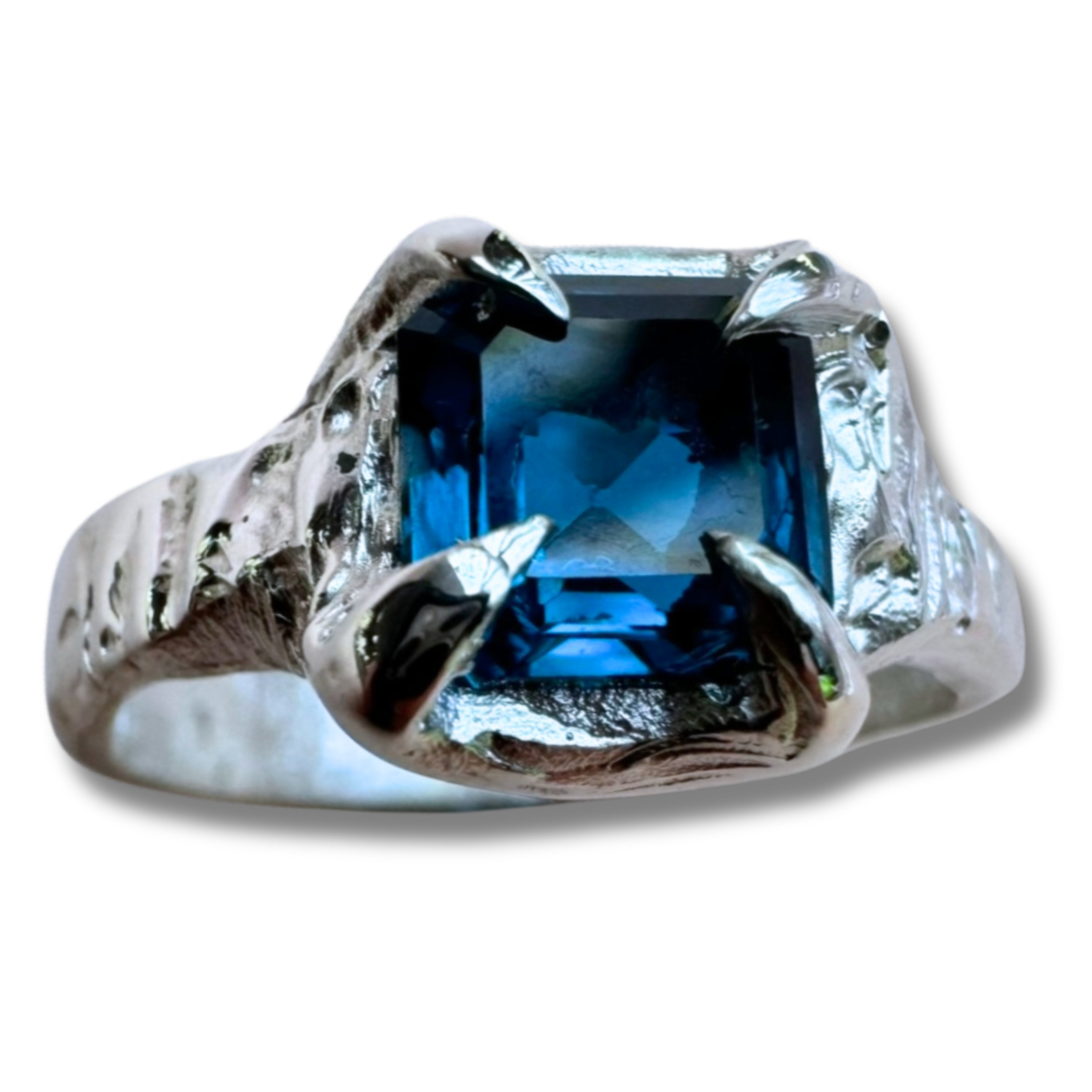 Sterling silver ring with claw setting and a cushion cut sapphire cast in place using wax carving technique.