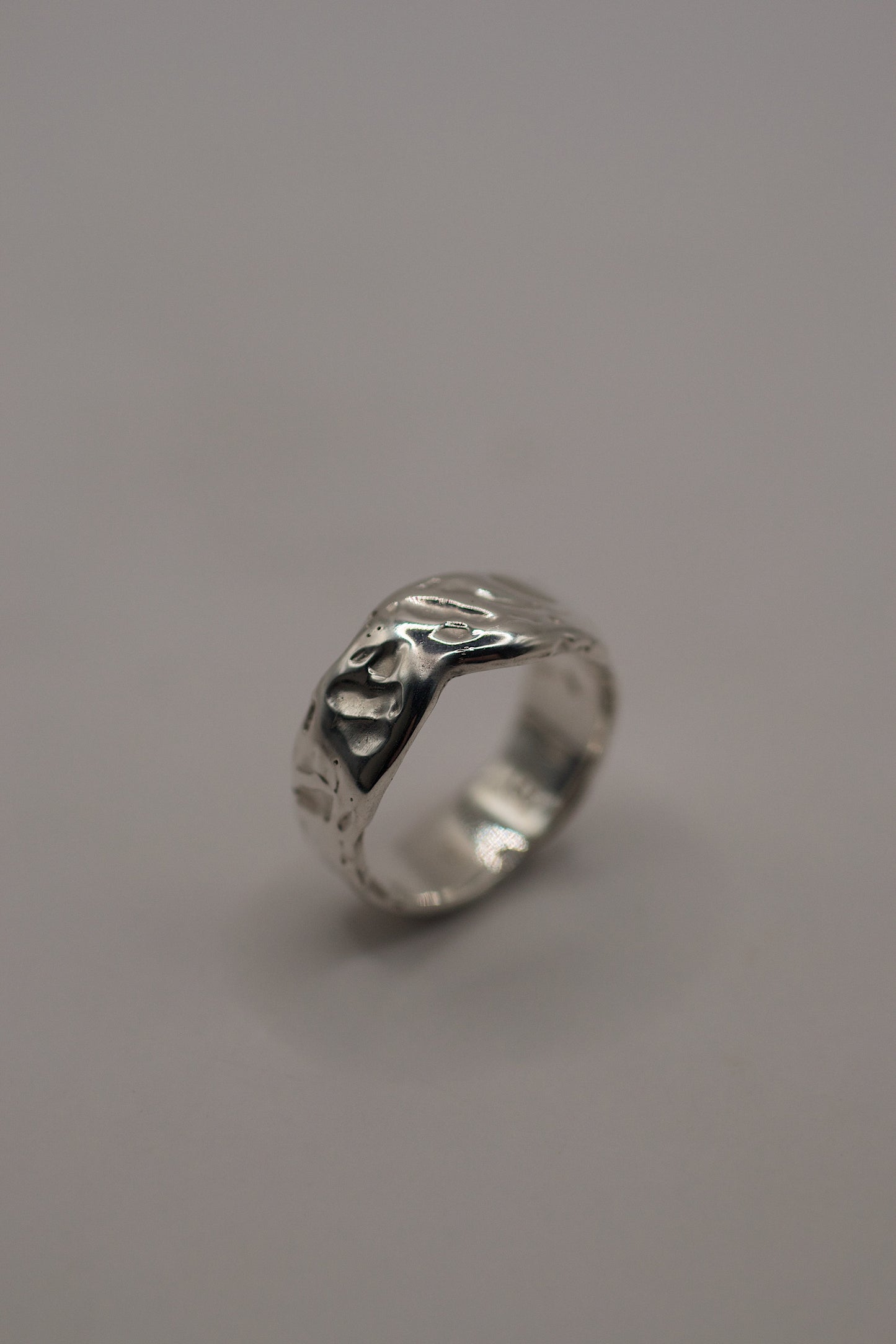 Upright silver ring with natural curves and deep texture, made using traditional lost wax jewellery casting
