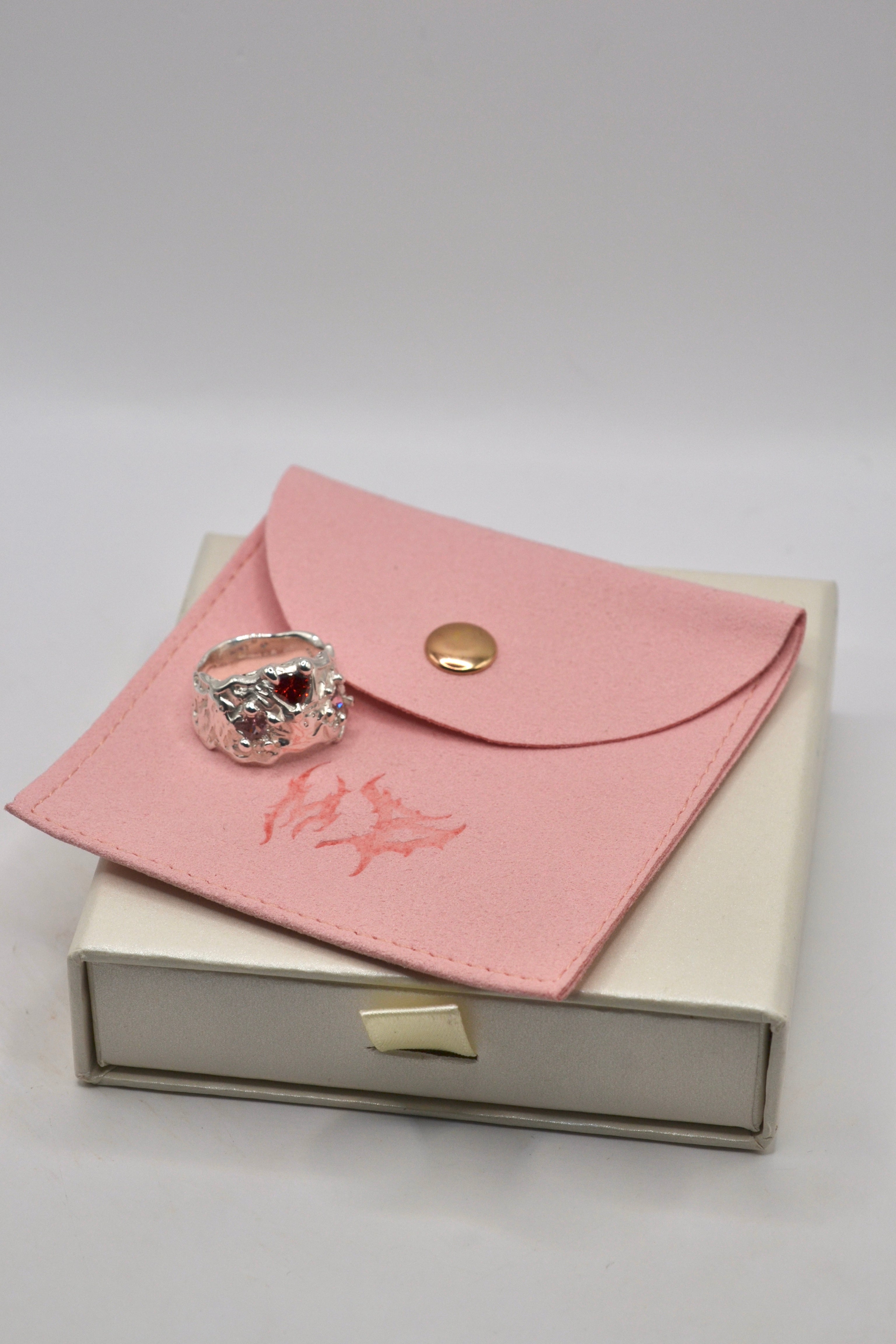 Cosmic Cowgirl ring on metal bones packaging flat lay