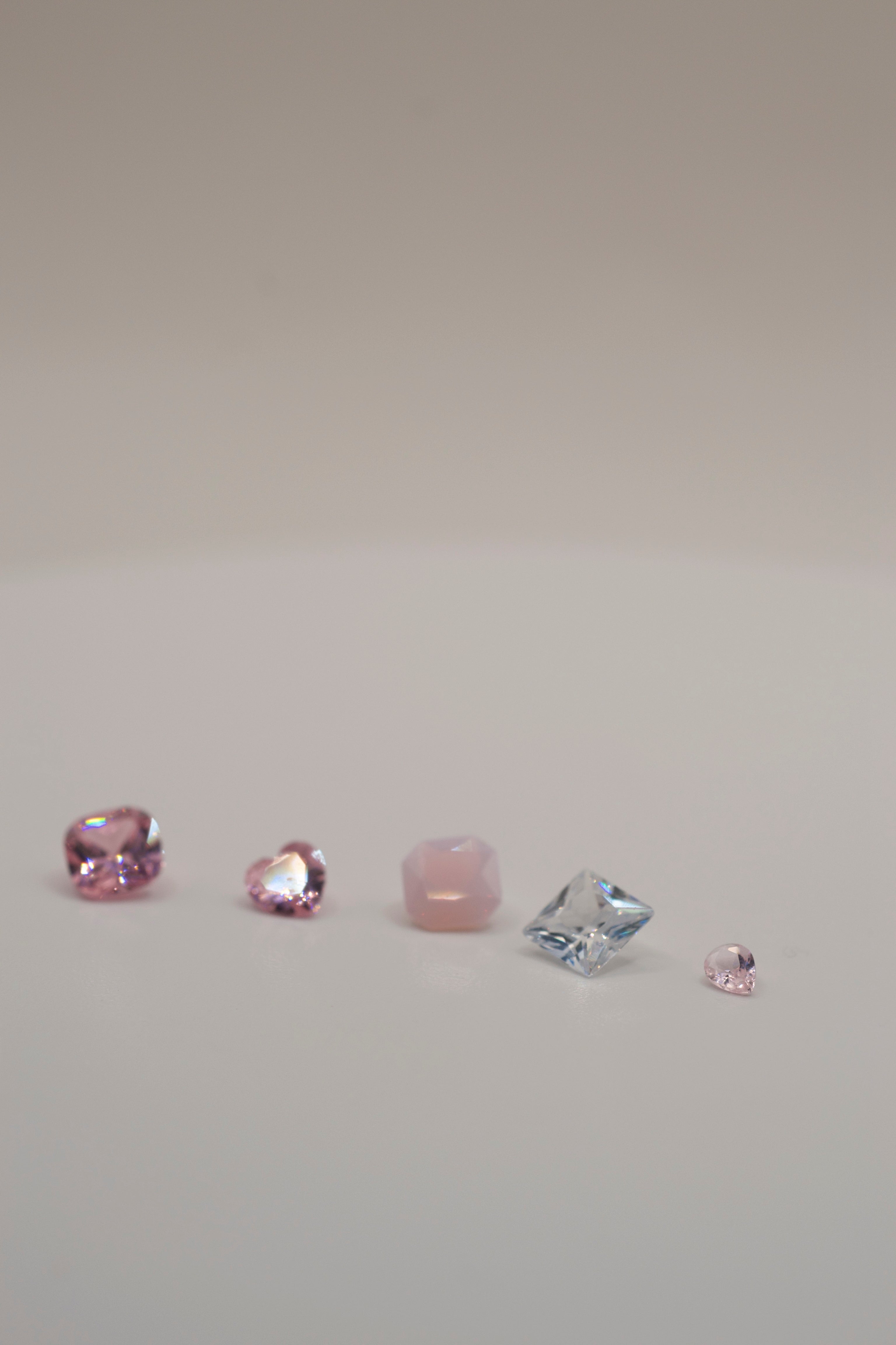 Loose pink and clear gemstones for jewellery making with lost wax method. Includes faceted stones in multiple cuts for cast in place designs.
