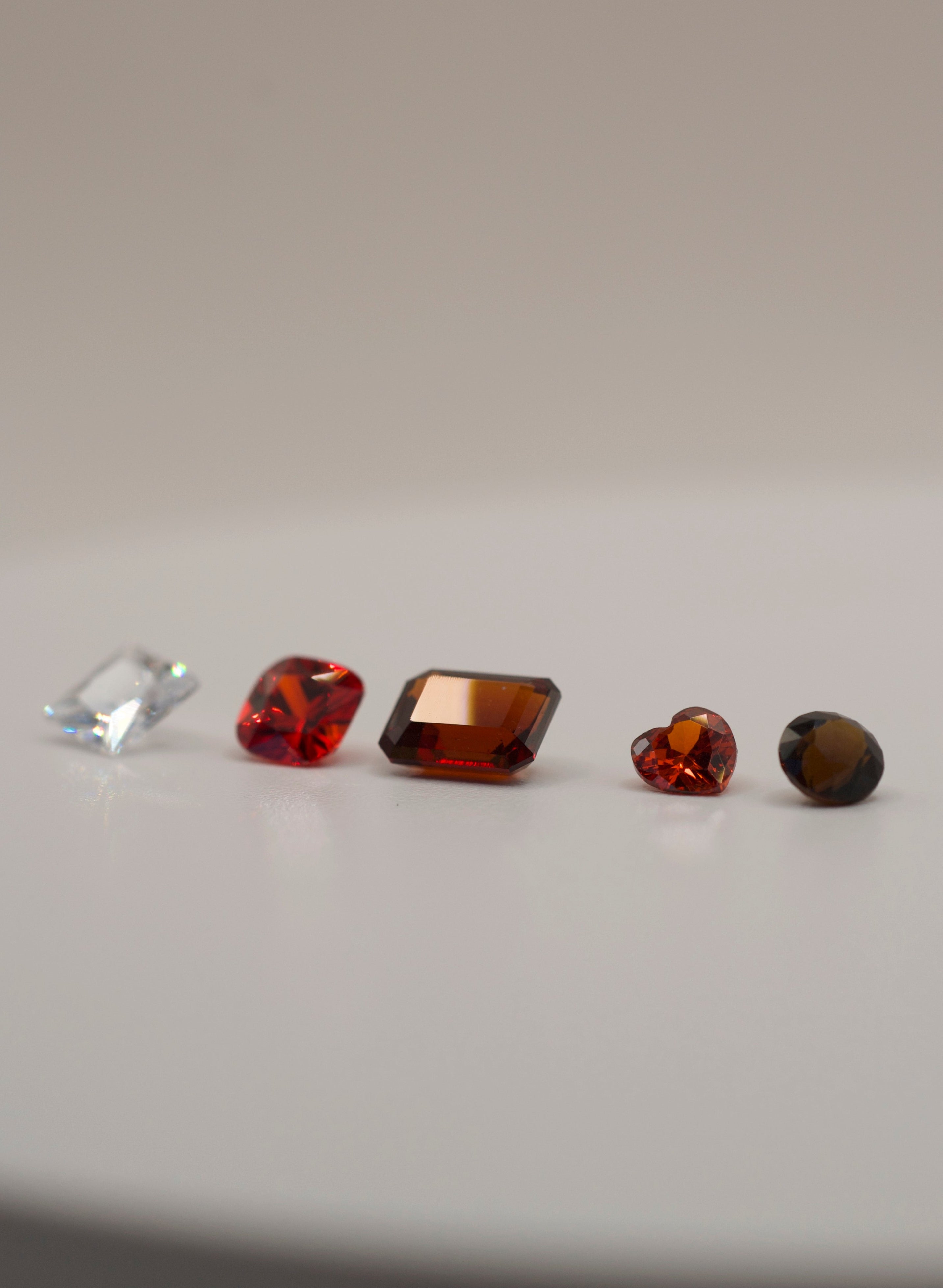 Loose gemstones for lost wax carving and casting in place, displayed on a white background.