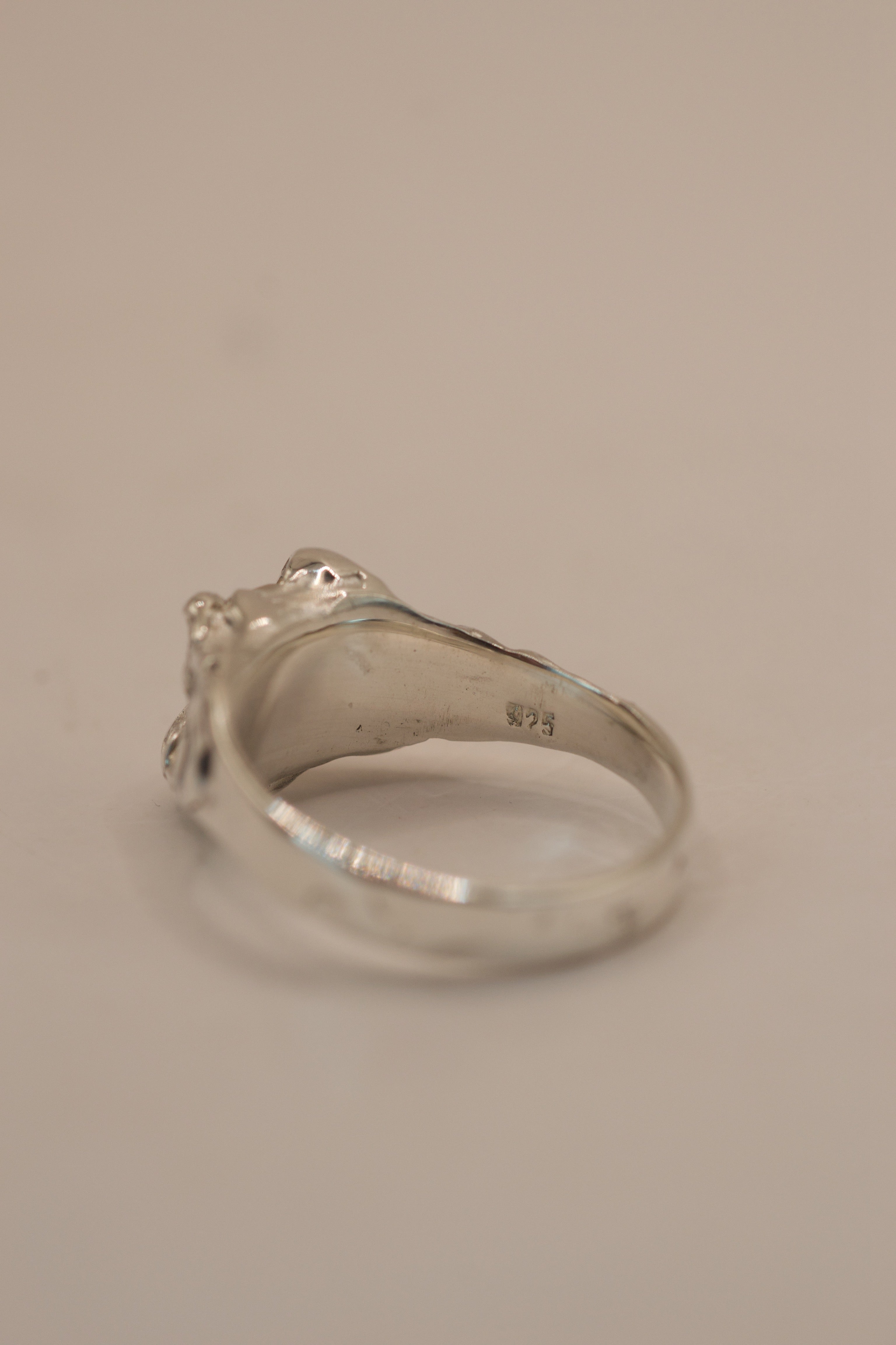 Handmade lost wax sterling silver organic engagement ring with gothic inspired claws securing a pear cut moissanite stone.