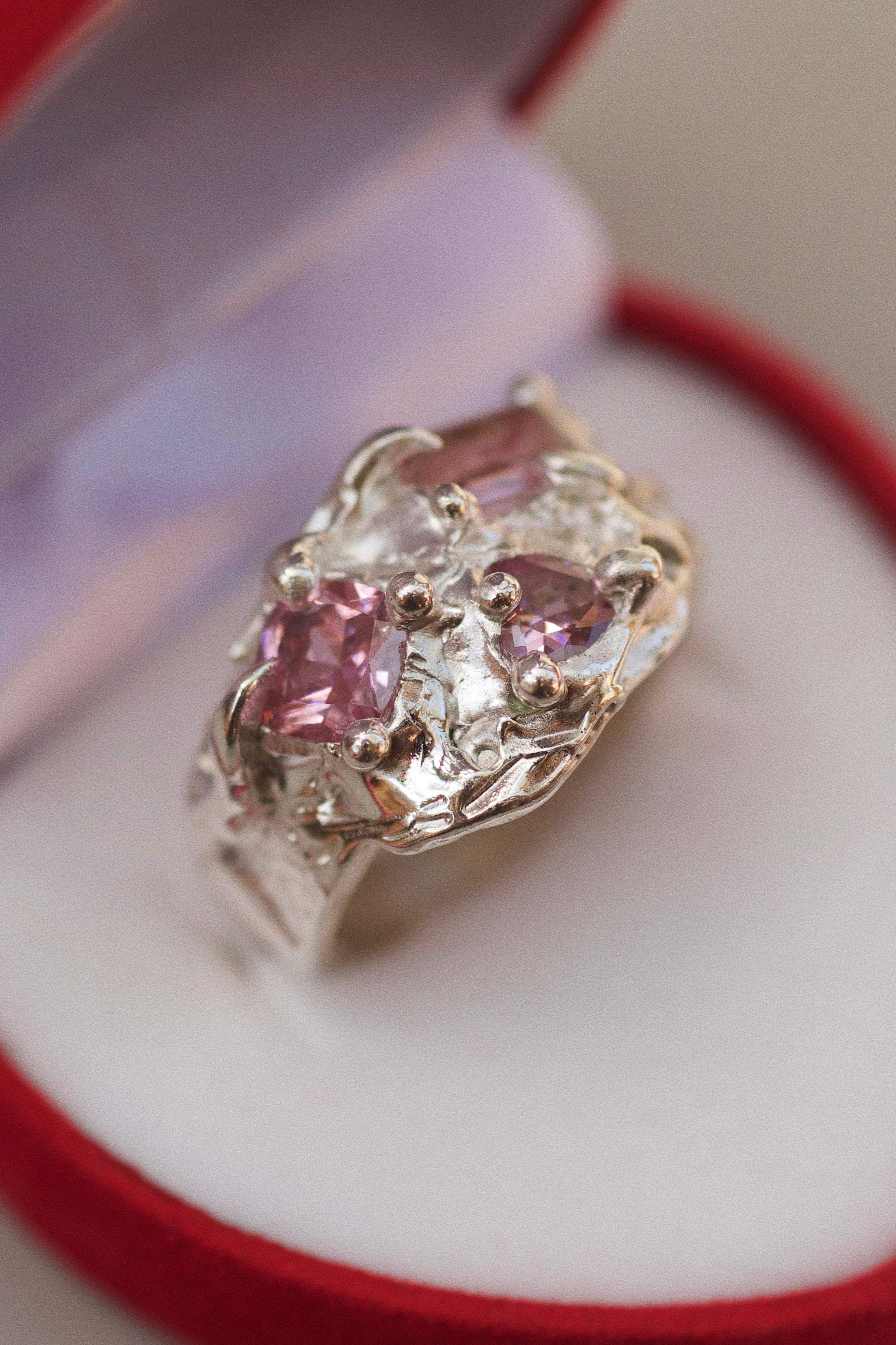 Los wax cast sterling silver molten ring with three light pink gemstones cast in place. 