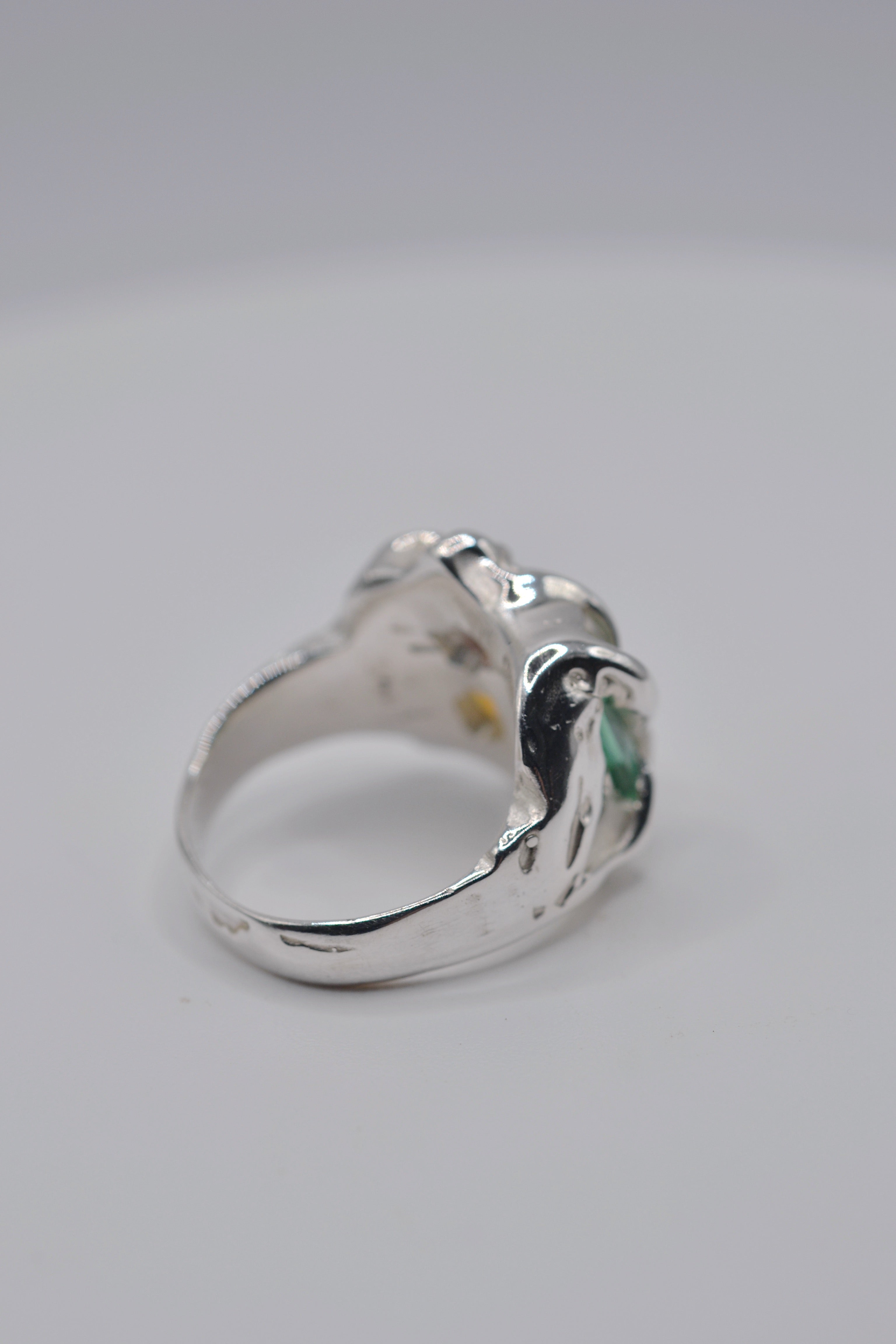 Side profile of the Mirage ring. Handmade organic silver, wax carved and lost wax cast. Green tourmaline, pink heart CZ and milky yellow opal. Metal Bones Jewellery.
