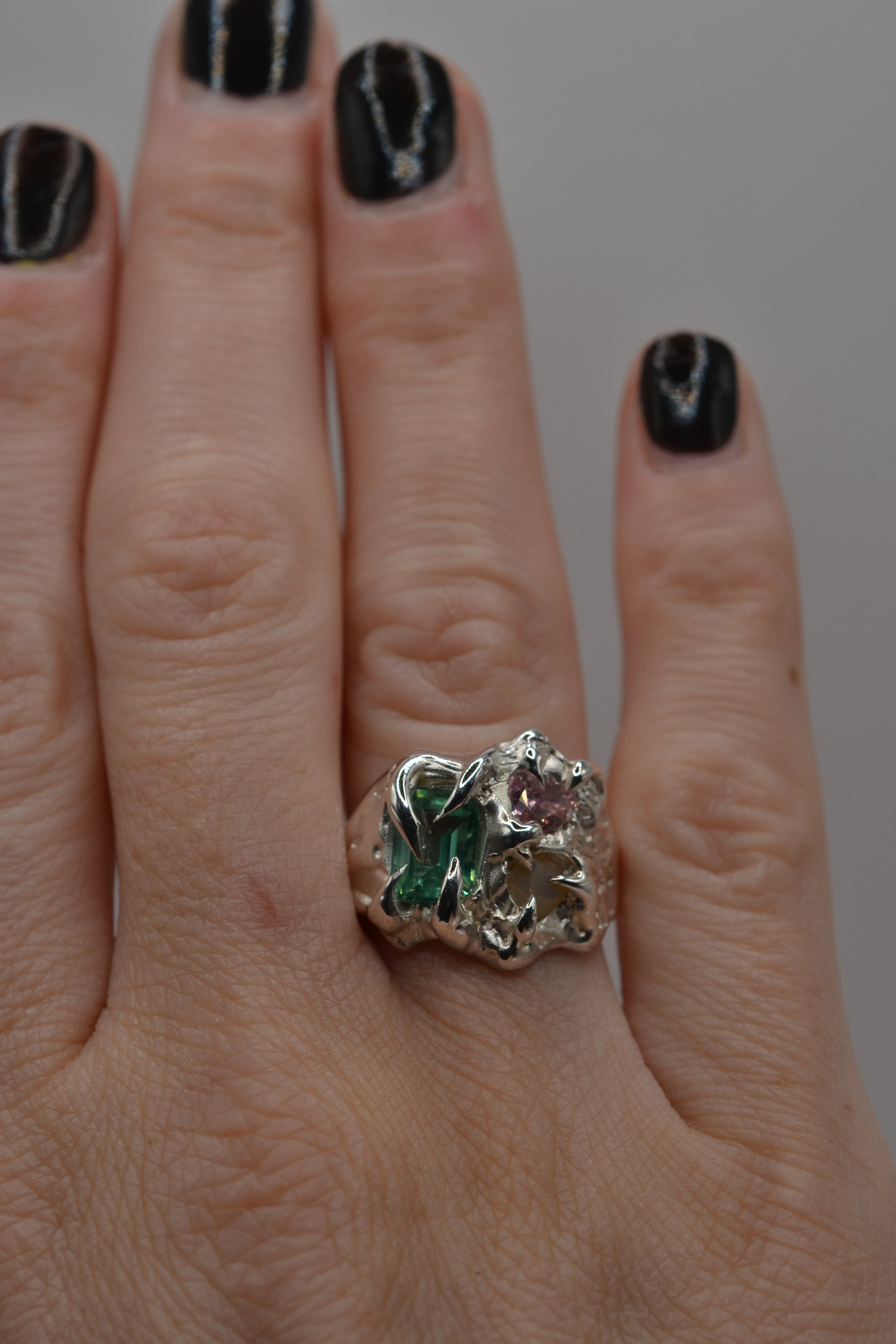 The Mirage worn. Handmade organic silver ring, wax carved and lost wax cast. Unique alternative engagement ring with multi stone detail. Metal Bones Jewellery.