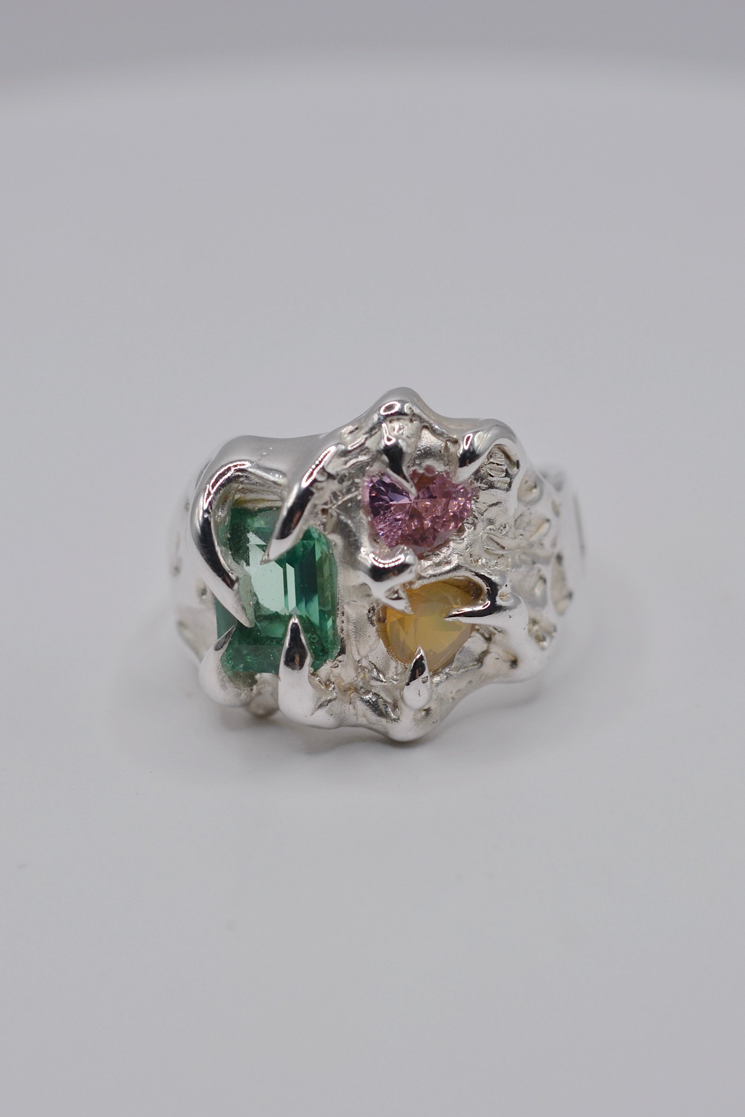 The Mirage. Handmade organic silver ring sculpted using wax carving and lost wax casting. Set with lab-grown green tourmaline, pink heart cubic zirconia and milky yellow opal. Unique alternative engagement ring. Designed and made by Cassandra Djodan, Metal Bones Jewellery.
