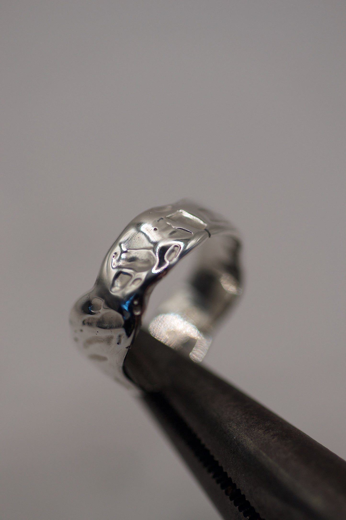 Close-up of organic molten textured sterling silver ring made using the lost wax jewellery technique
