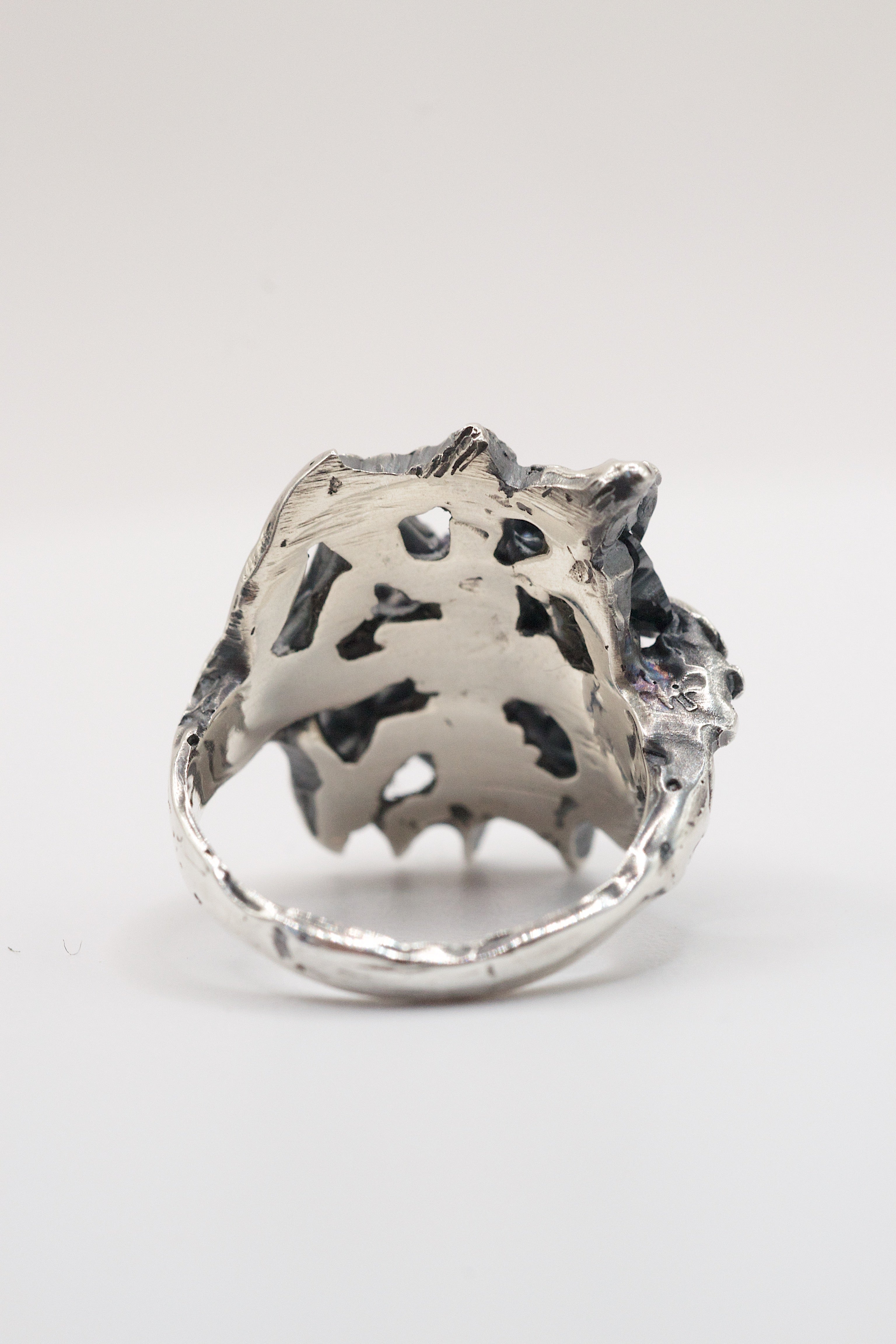 Grungy silver ring design with a molten finish, holding a hex-cut alexandrite and heart CZ in sculpted claw settings.